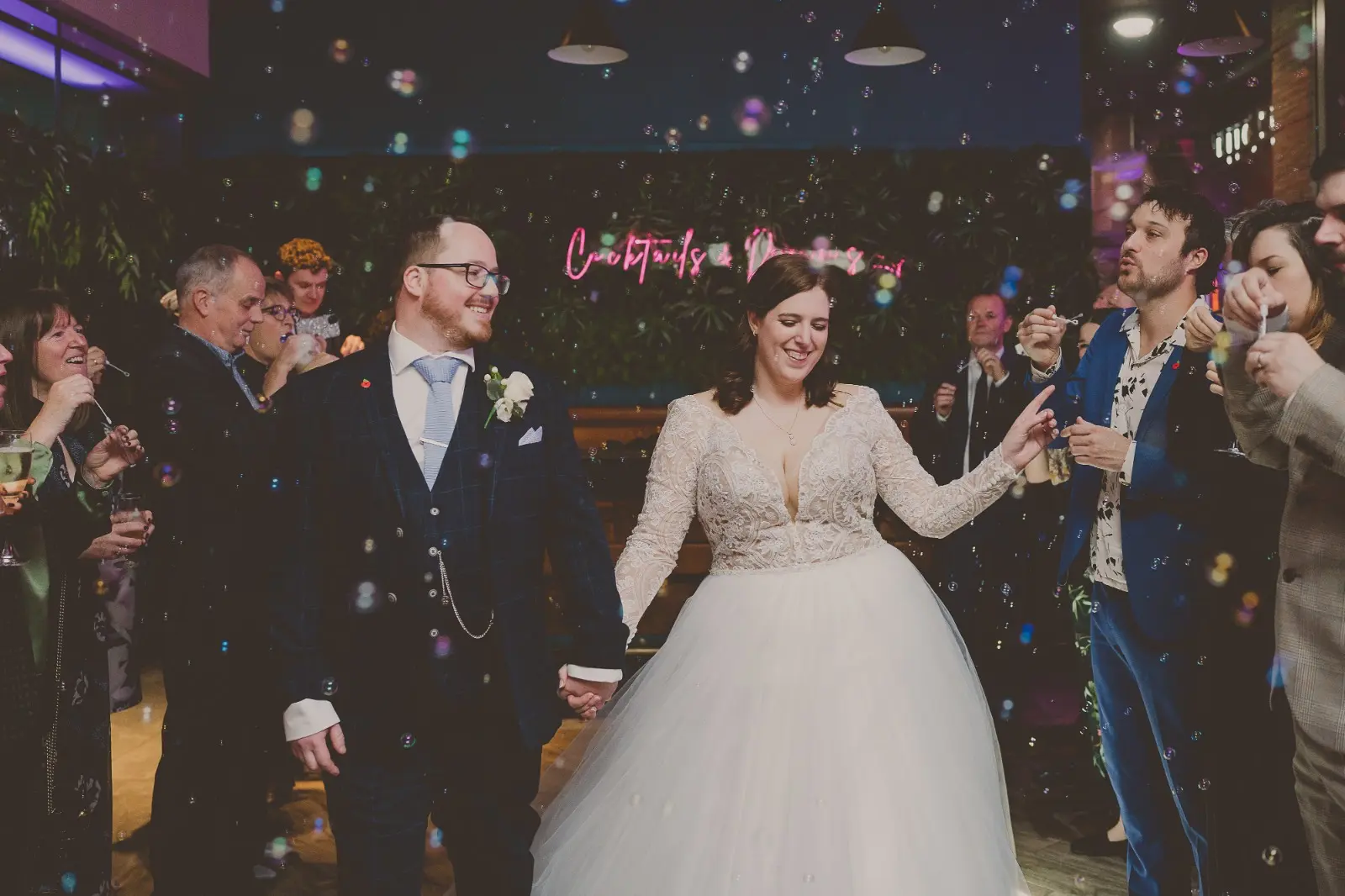 Bride And Groom Celebrating. Bride Wearing Lace Long Sleeve Ball Gown Wedding Dress With Tulle Skirt Called Mallory Dawn By Maggie Sottero