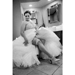 Bride wearing Elton wedding dress by Sottero and Midgley showing off her shoes