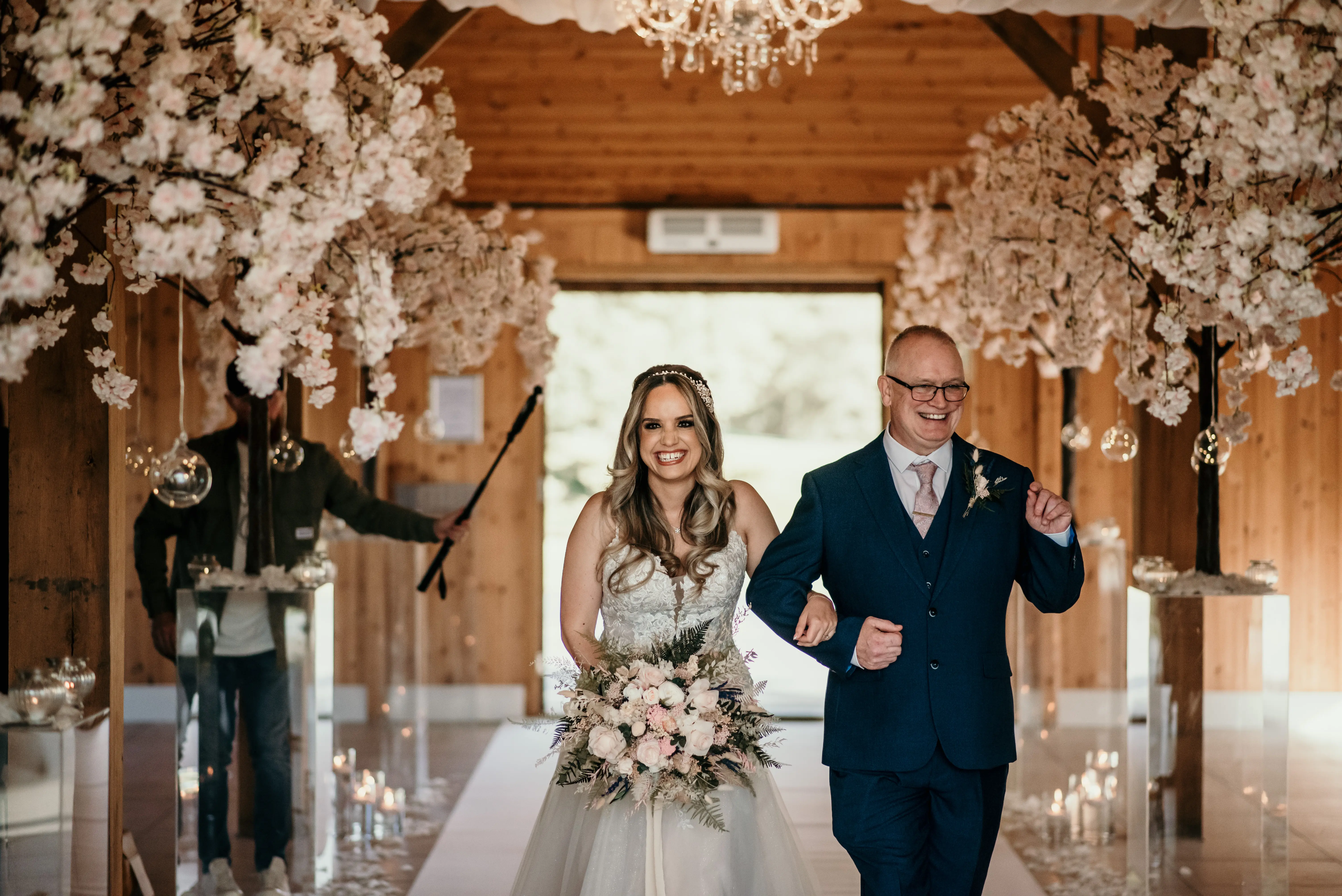 Bride wearing Stevie wedding gown by Maggie Sottero walking down the aisle
