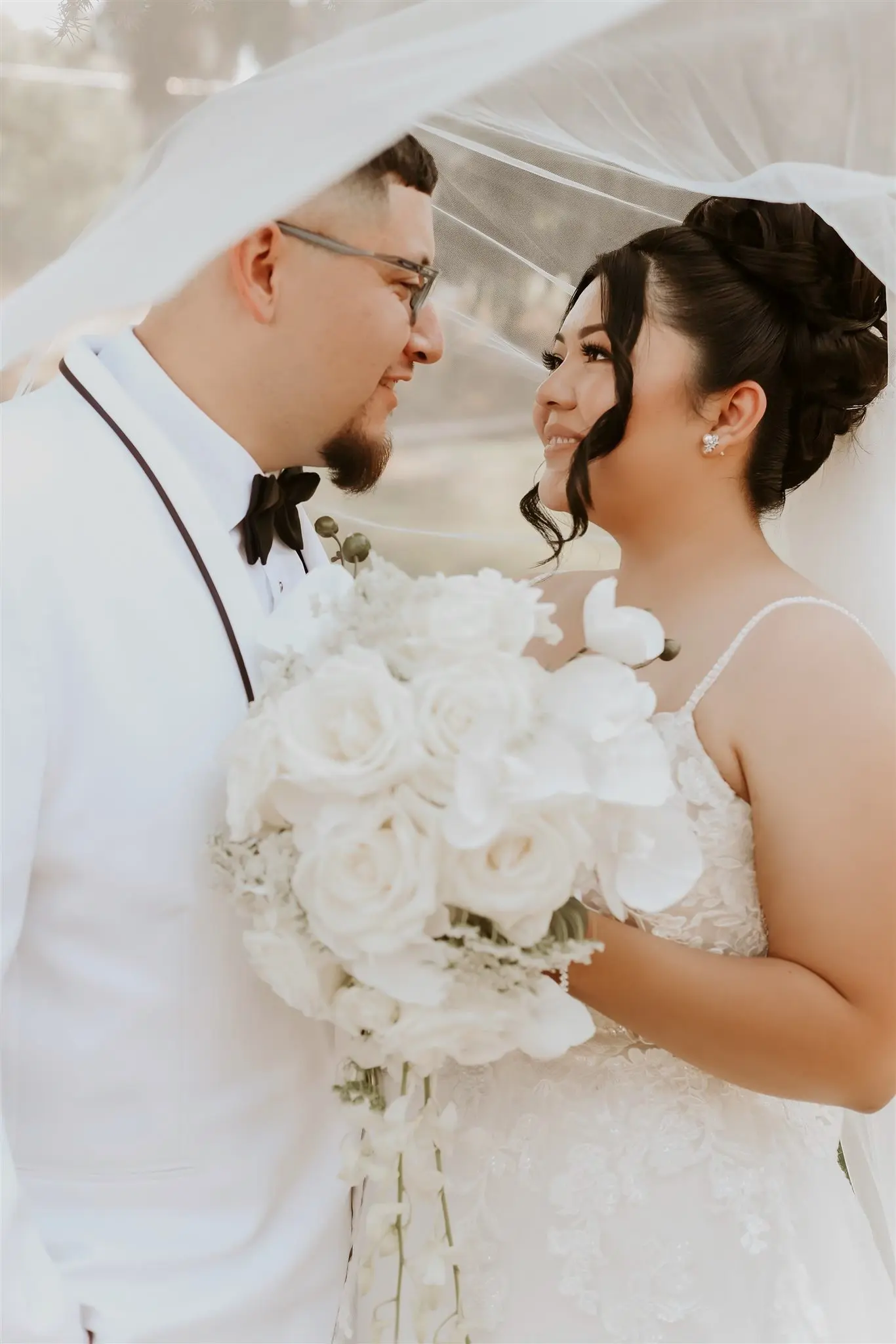 Bride wearing Stevie by Maggie Sottero under her veil with her husband