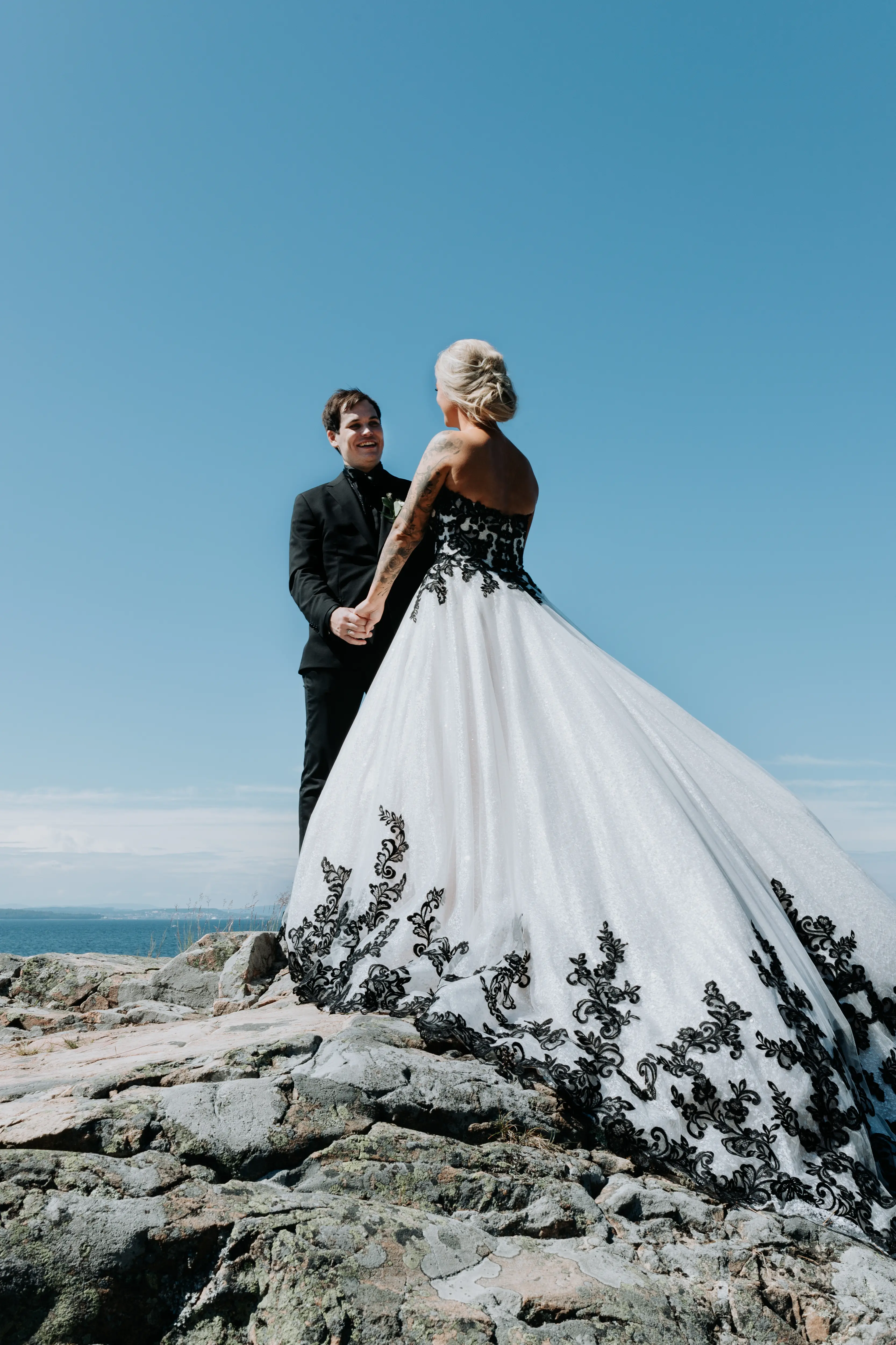 Groom With Bride Wearing Ballgown With Black Lace Detail Called Tristyn By Maggie Sottero