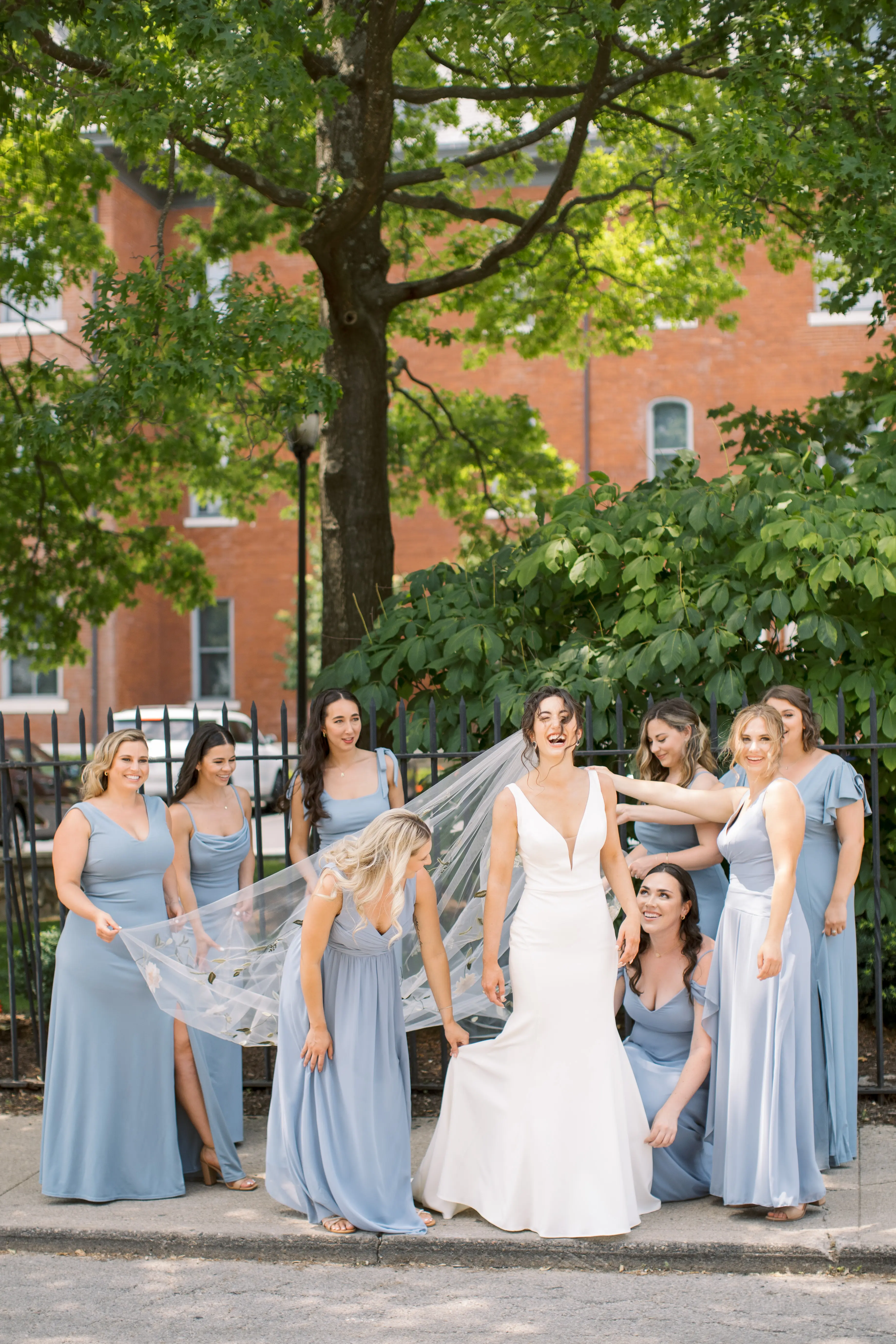 Bride In Simple Crepe V-neck Theodora Rebecca Ingram With Bridesmaids In Blue