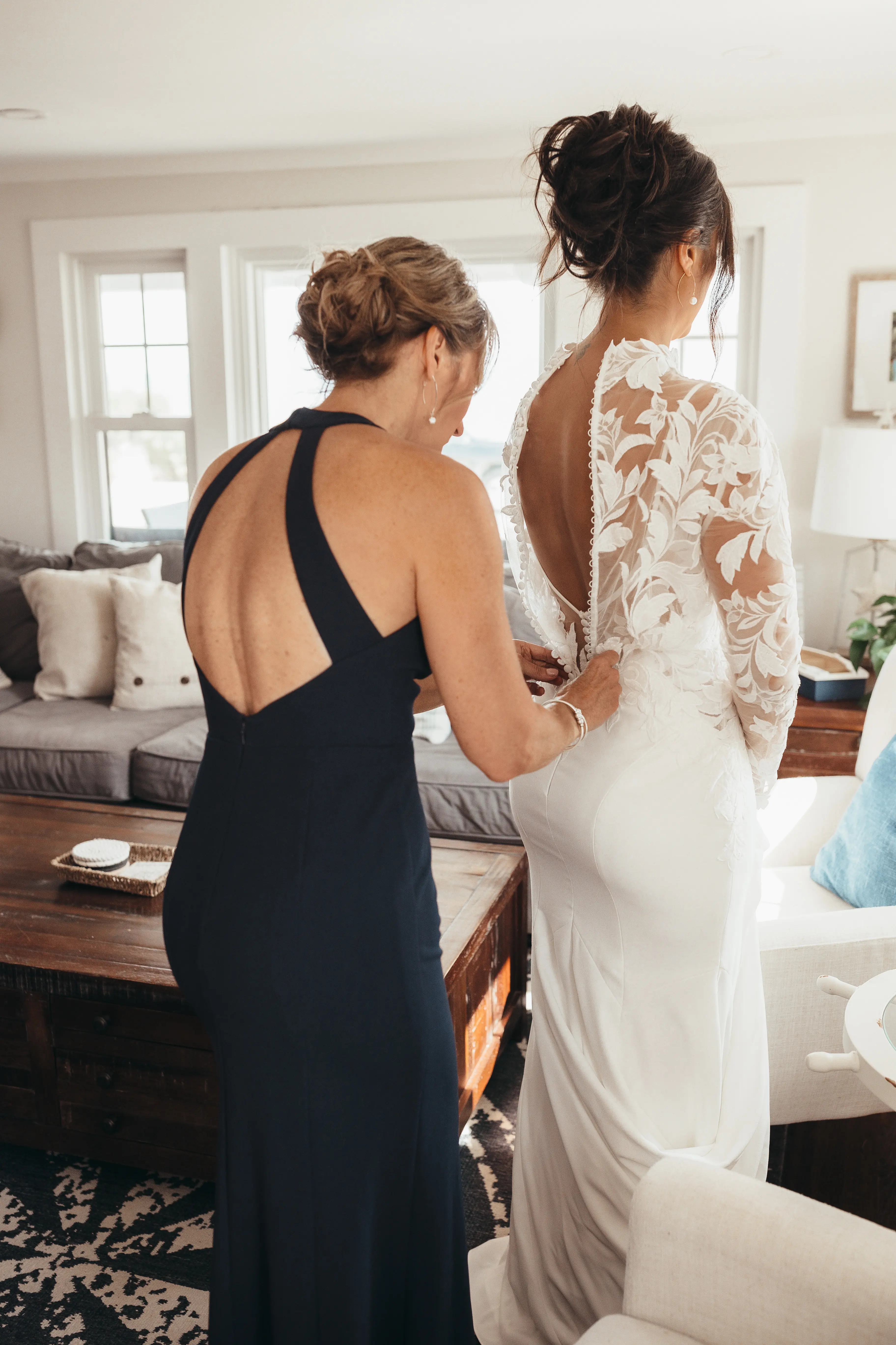 Bride Wearing Crepe And Lace Bridal Dress Called Dionne By Rebecca Ingram Getting Dressed
