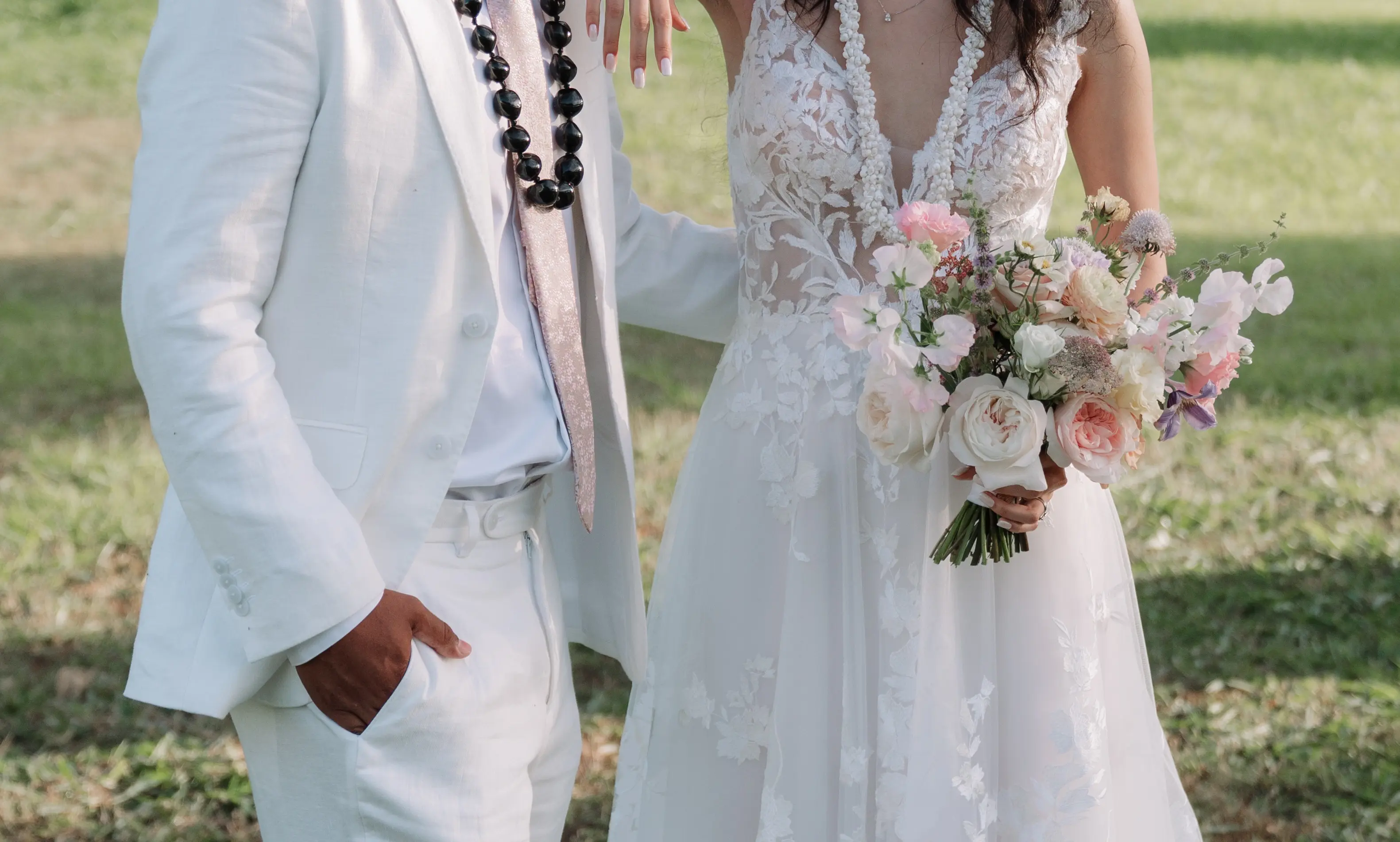 Bride wearing Winter wedding dress by Maggie Sottero stands with her husband