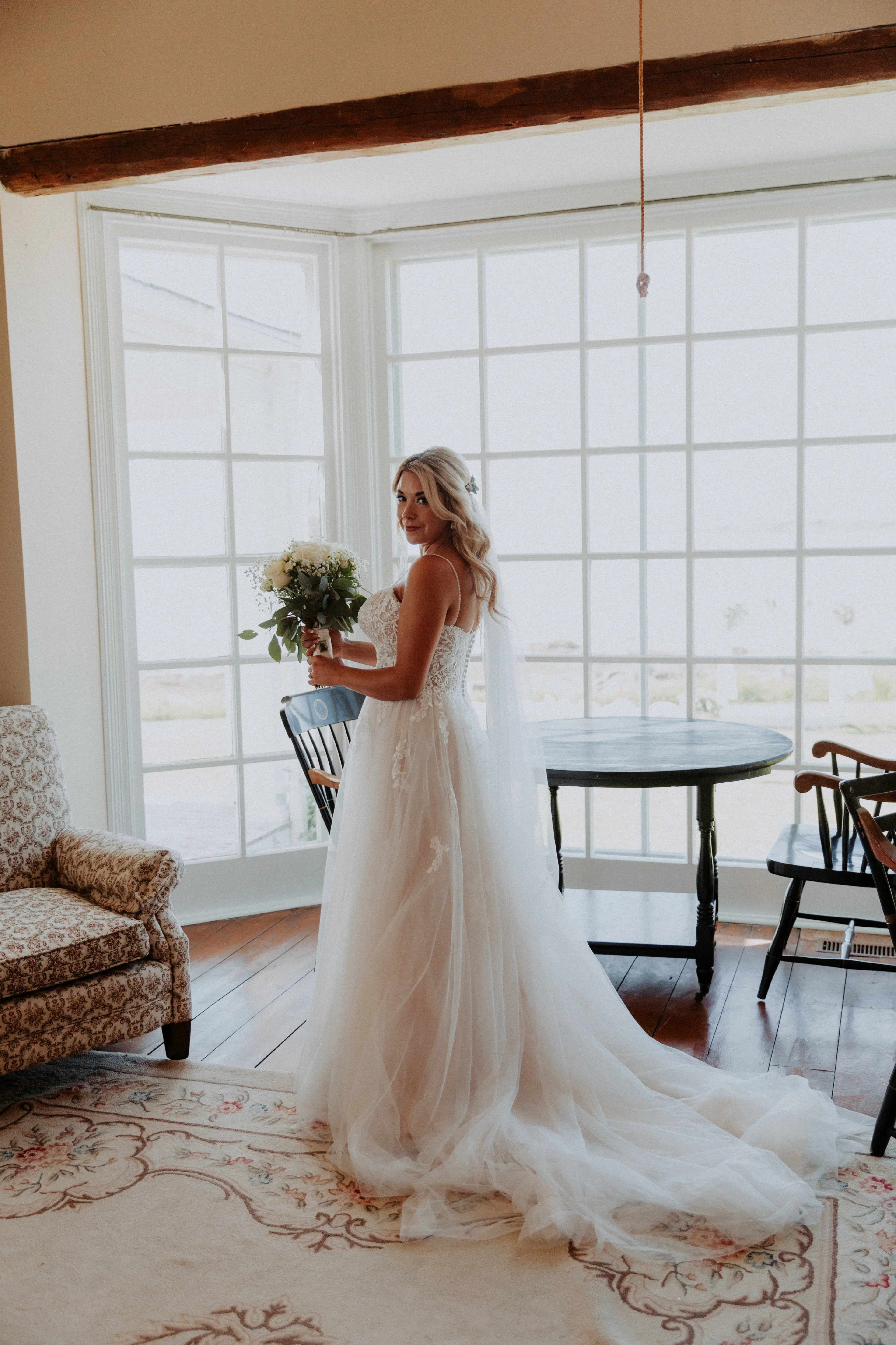 Bride in Flattering A-Line Spaghetti Strap Wedding Dress with Romantic Lace Called Marisol by Rebecca Ingram