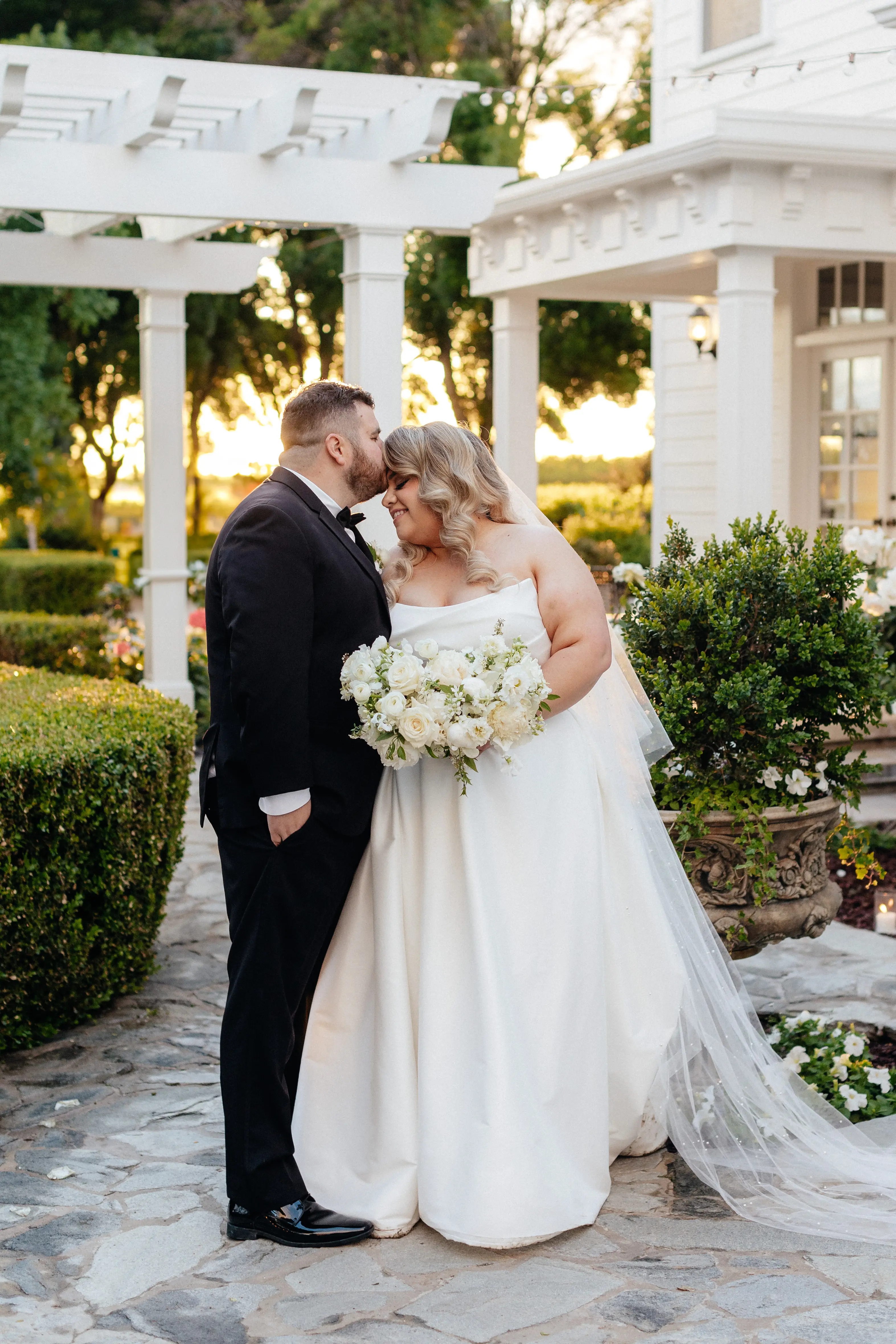 Bride wearing Aspen by Sottero and Midgley being kissed by her husband