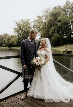 Bride wearing Rousseau wedding dress by Maggie Sottero with her husband