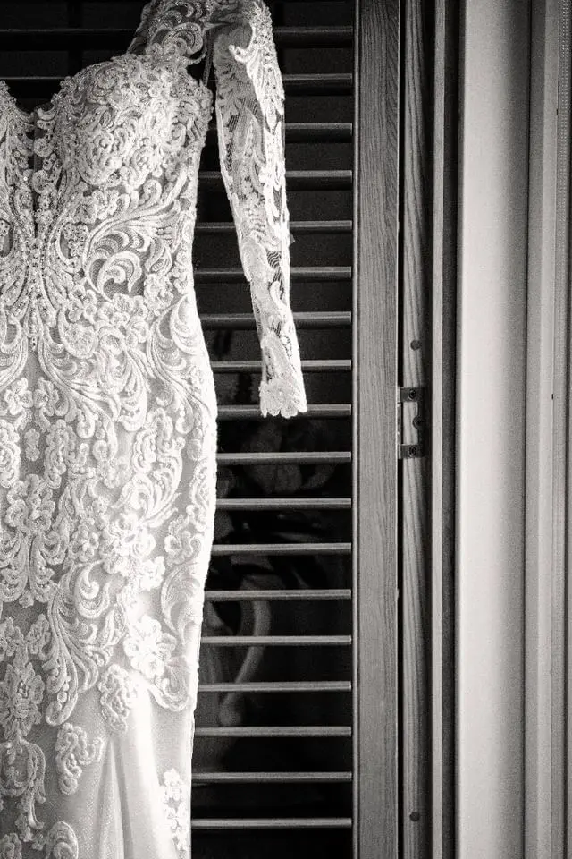Sparkly Fit-And-Flare Wedding Dress Called Fiona By Maggie Sottero Hanging In A Doorframe