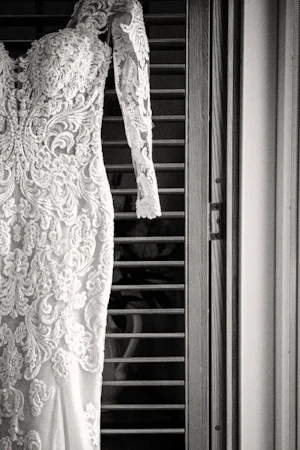 Sparkly Fit-And-Flare Wedding Dress Called Fiona By Maggie Sottero Hanging In A Doorframe