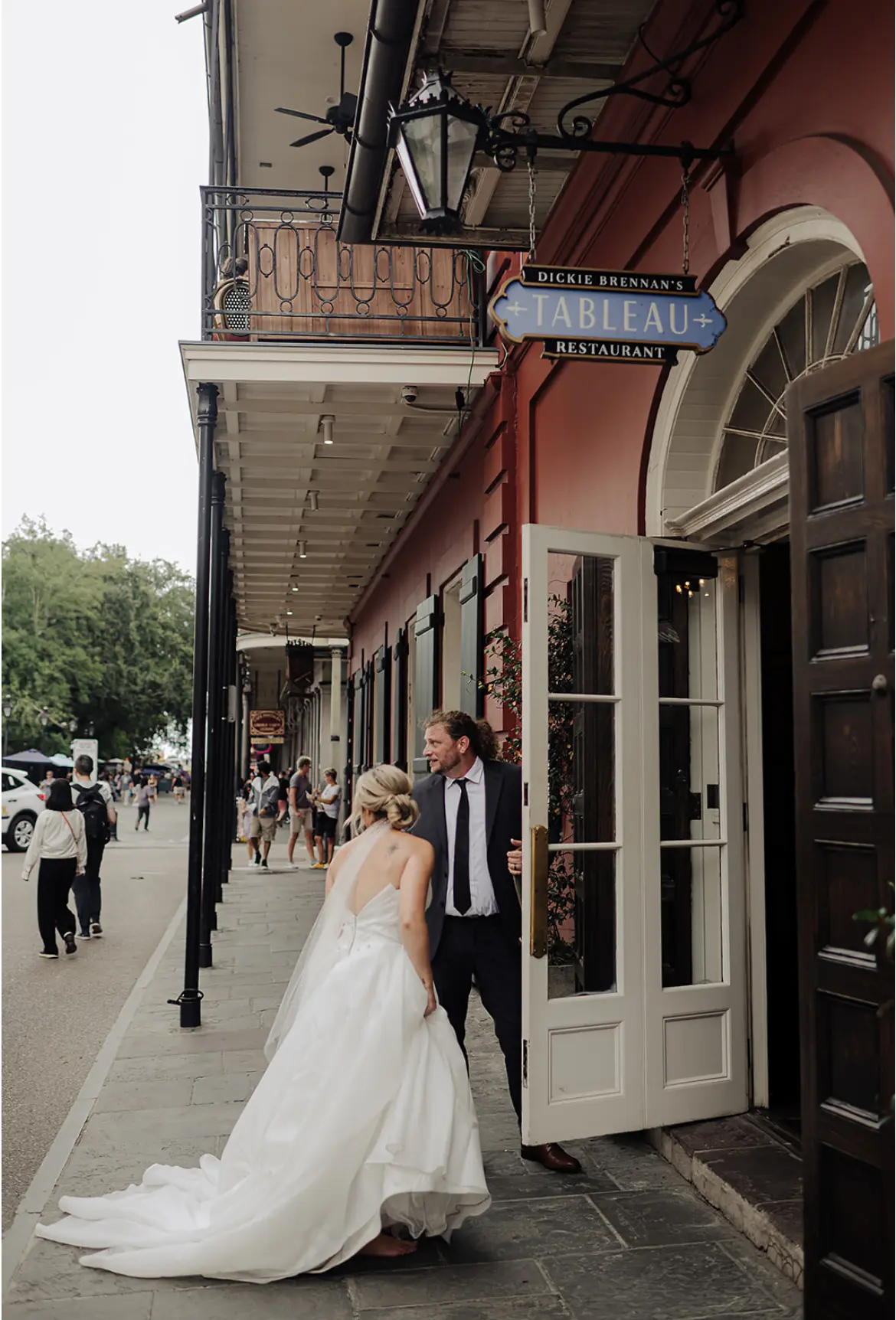 Bride Wearing Modern Princess Wedding Dress Called Aubrielle By Maggie Sottero Walking With Groom In New Orleans