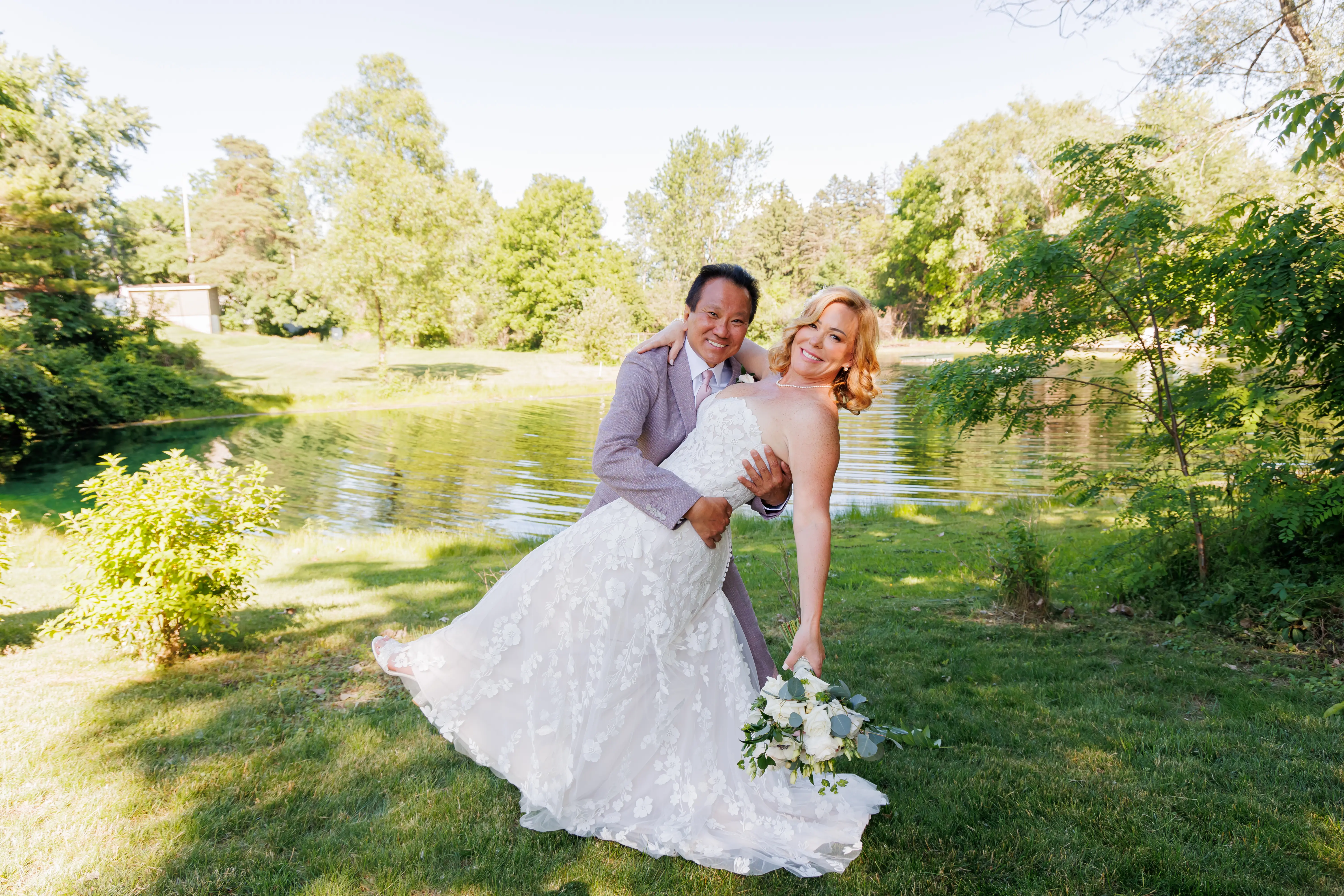 Bride wearing Demetria by Maggie Sottero being dipped by her husband