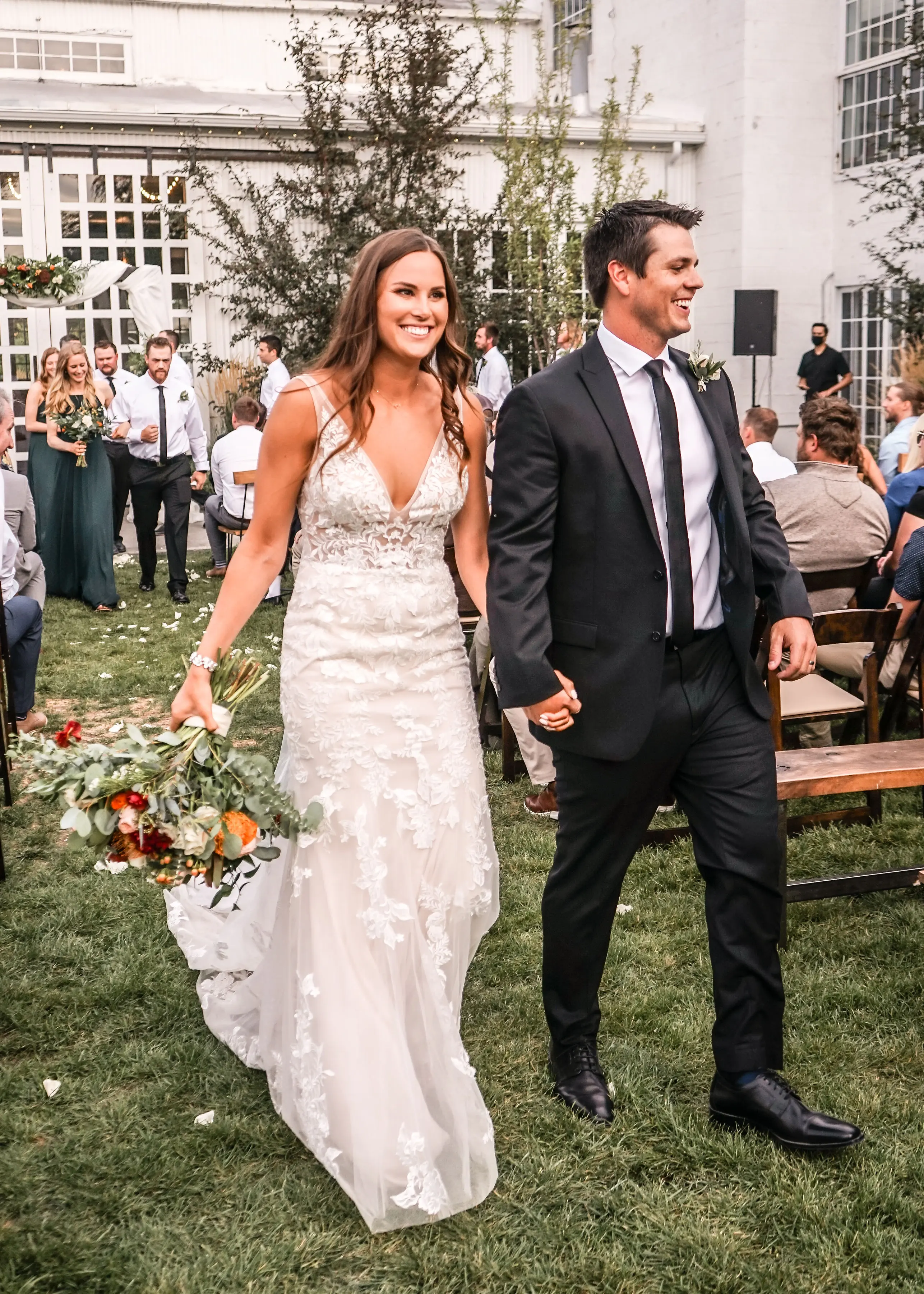 Groom with bride wearing sexy fit and flare wedding dress called Greenley by Maggie Sottero.