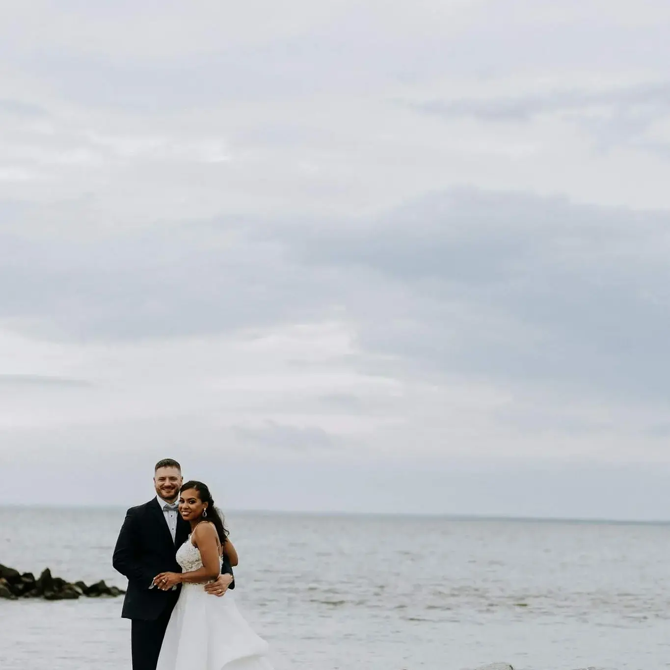 Bride Wearing Flirty A-line Wedding Gown Called Savannah By Maggie Sottero On The Beach With Groom