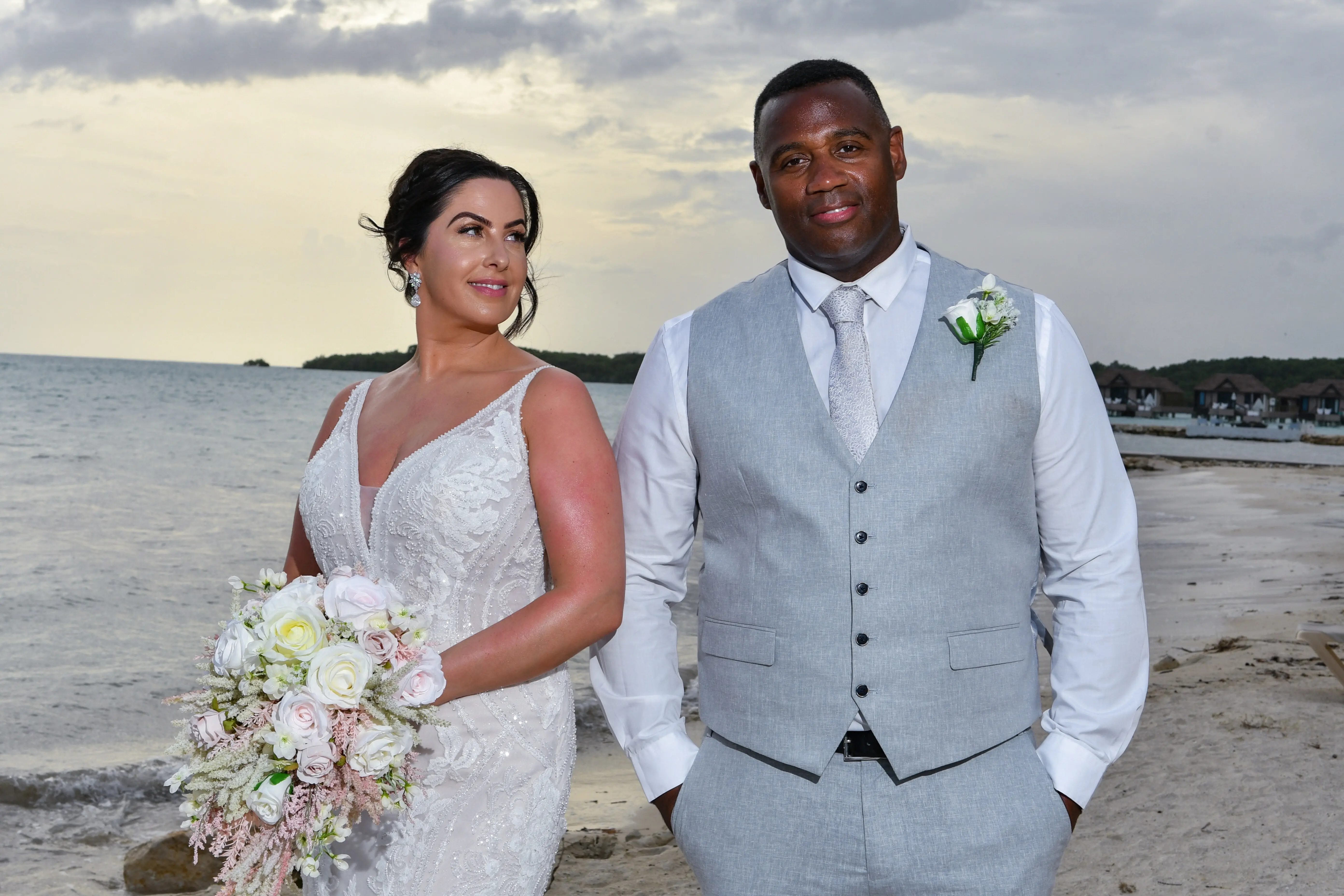 Bride wearing Franklynn by Sottero and Midgley with her husband on the beach