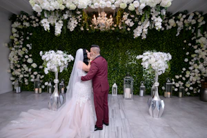 Bride and groom kissing surrounded with ivory florals.