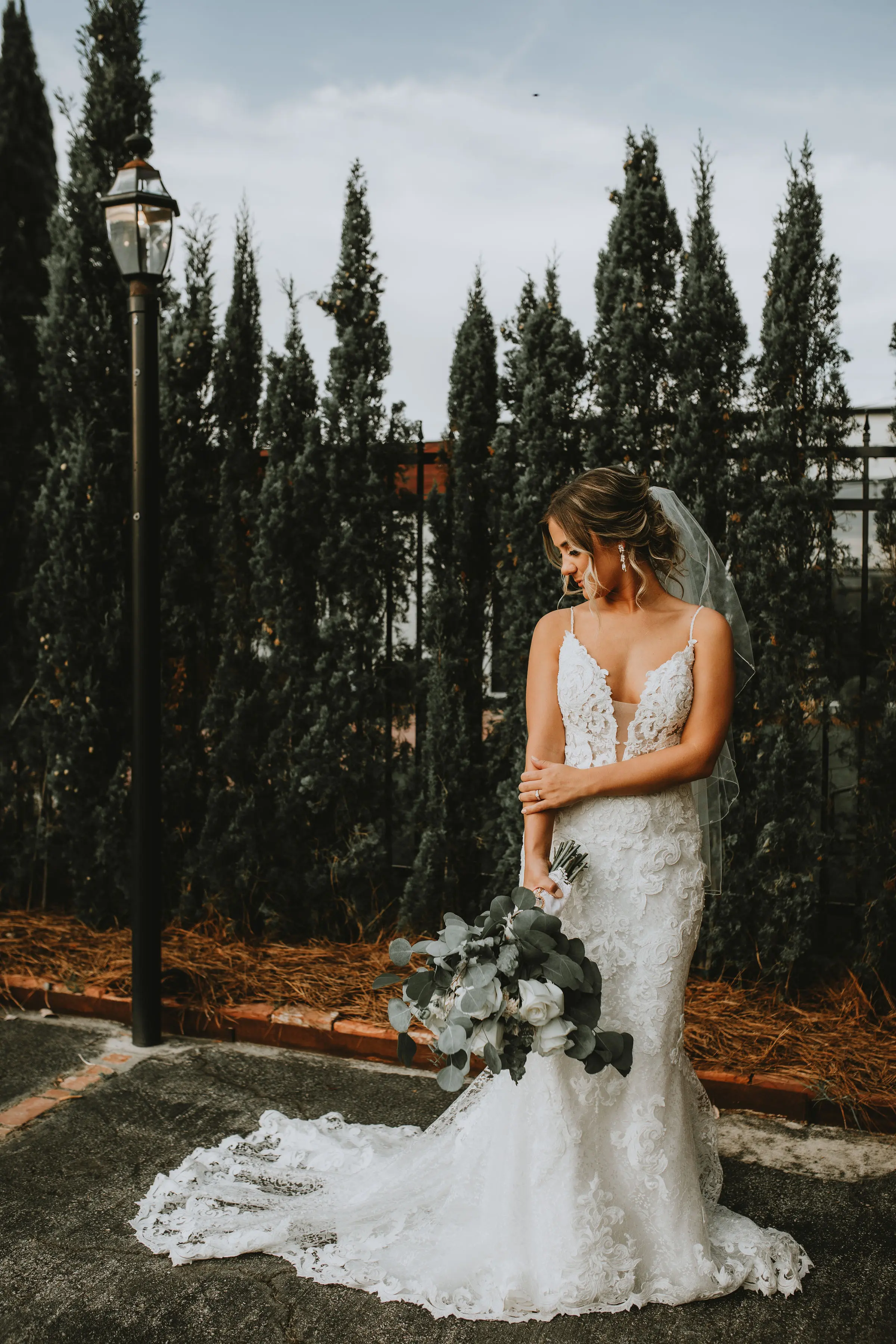 Bride in romantic lace sheath wedding dress