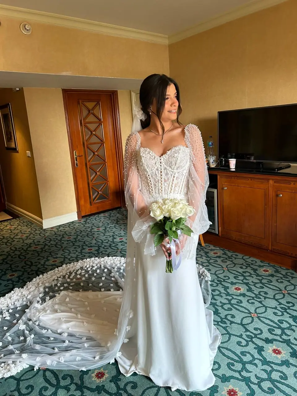 Bride Wearing Sheath and Beaded Wedding Dress Called Doritte By Maggie Sottero In A Hotel Room