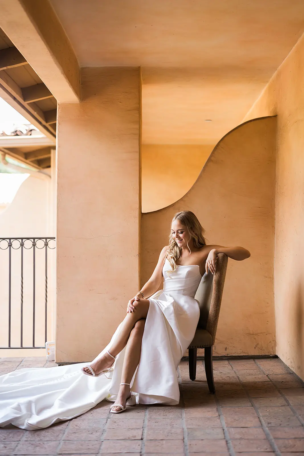 Bride wearing Aspen wedding dress by Sottero and Midgley sitting down