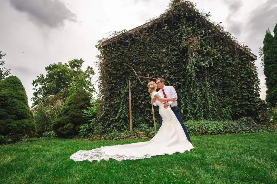 Bride wearing Josie by Rebecca Ingram kissing her husband