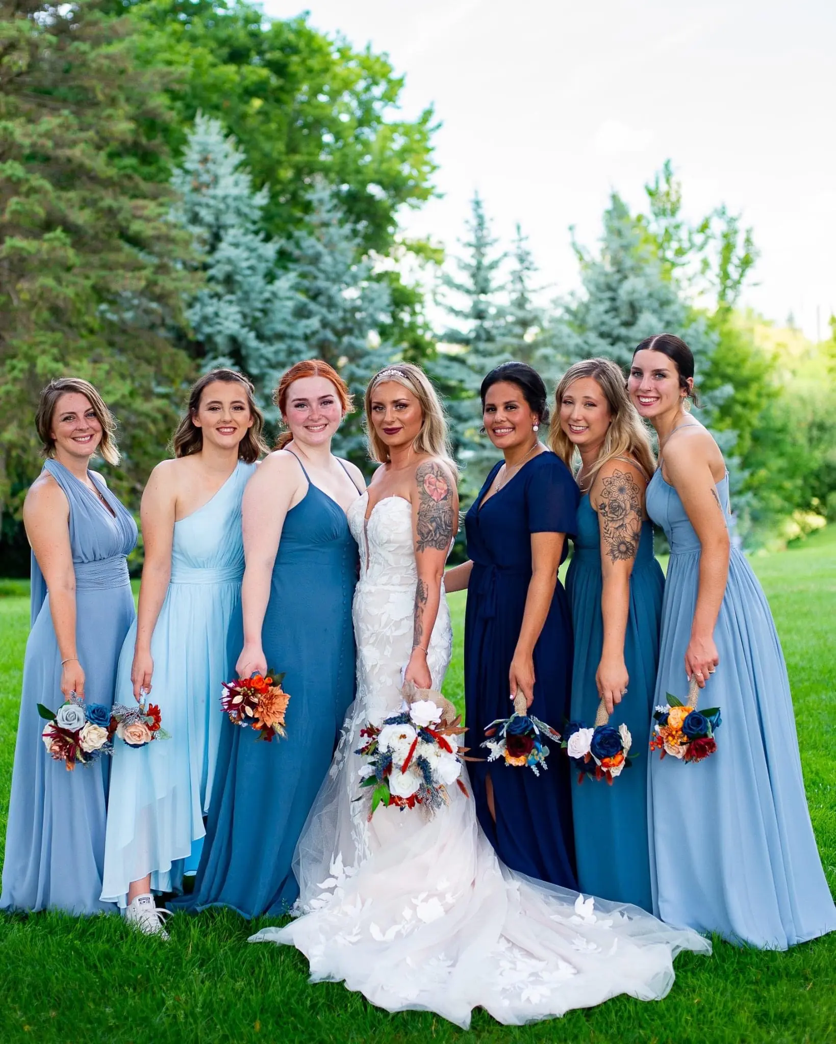 Bride Wearing Lace Strapless Mermaid Wedding Dress Called Hattie By Rebecca Ingram With Bridesmaids Holding Bouquets