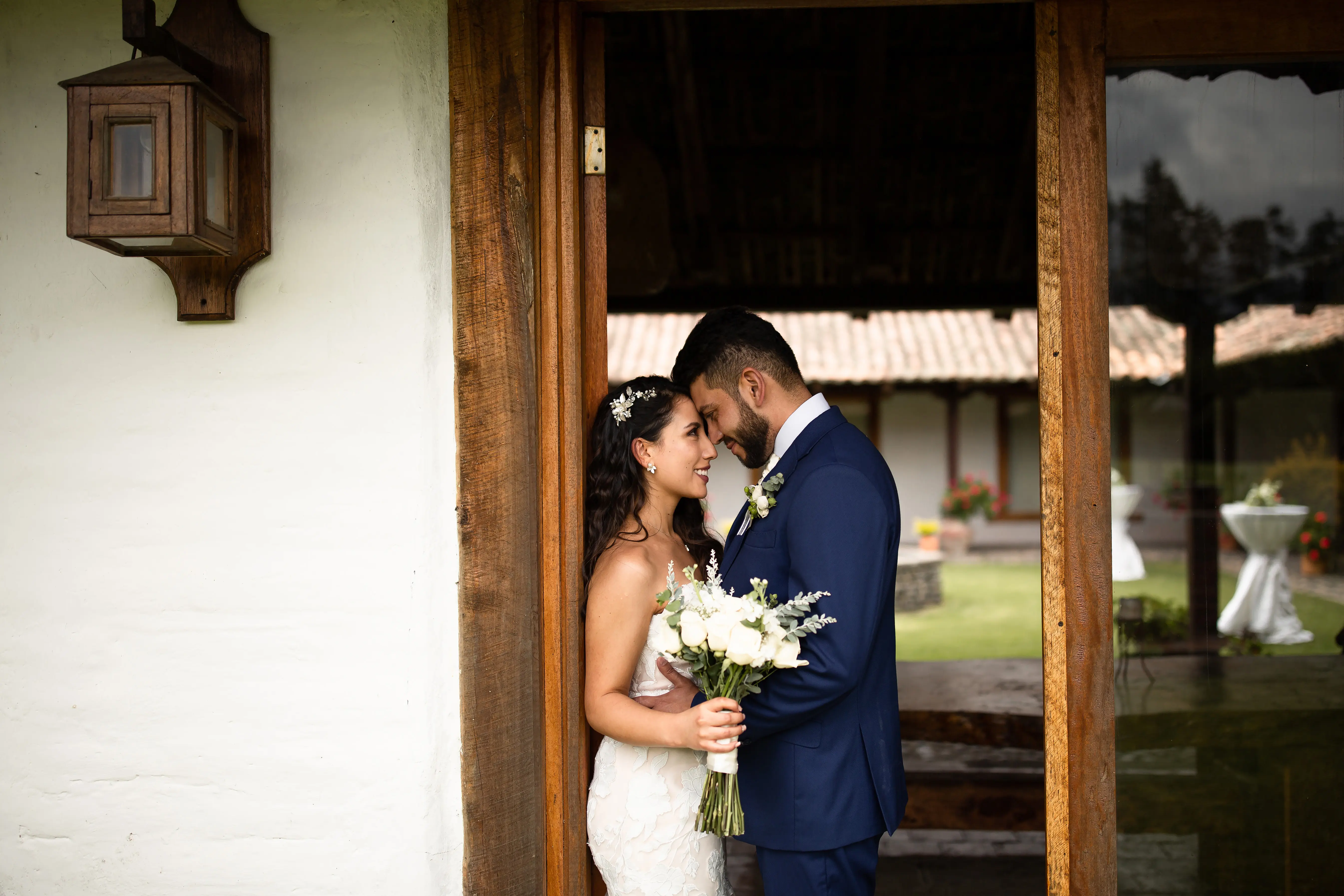 Bride with groom wearing affordable, strapless mermaid wedding dress.