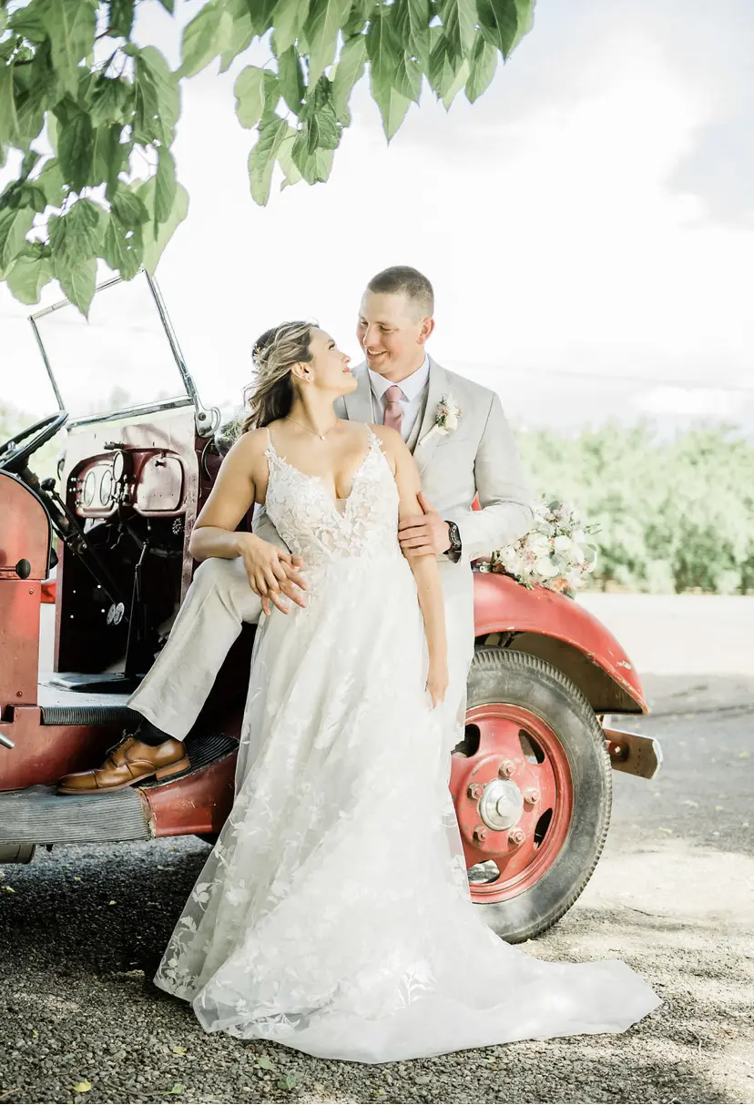 Groom Hugs Bride Wearing Floral Fairytale Wedding Dress Winter by Maggie Sottero
