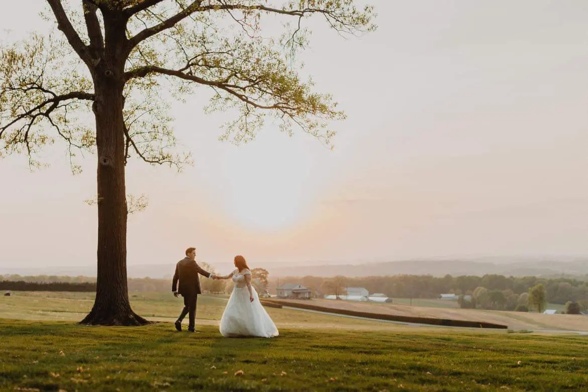 Bride wearing Mason by Sottero and Midgley and her husband under a tree