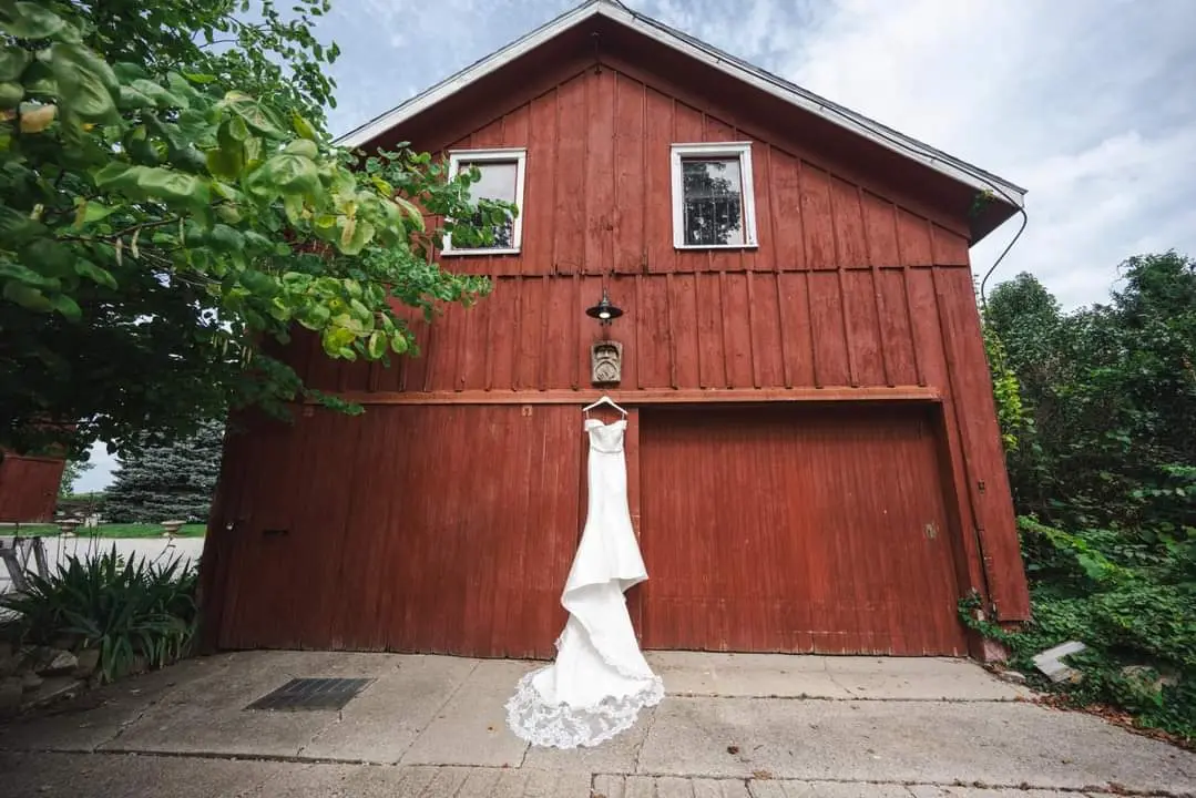 Josie by Rebecca Ingram hanging up on a red barn