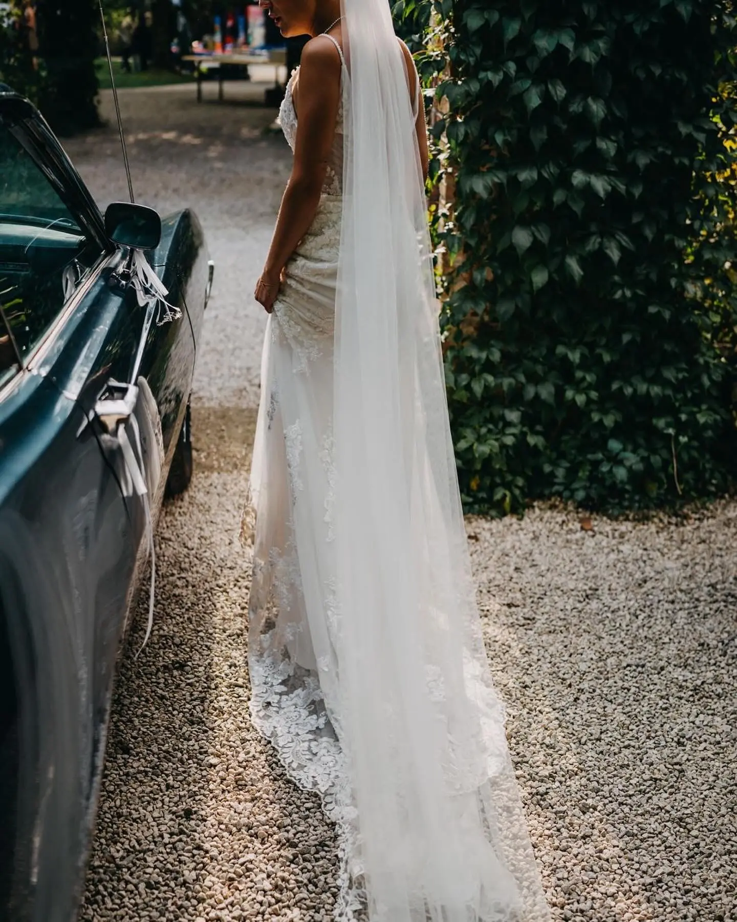 Bride wearing Fontaine by Maggie Sottero next to a car