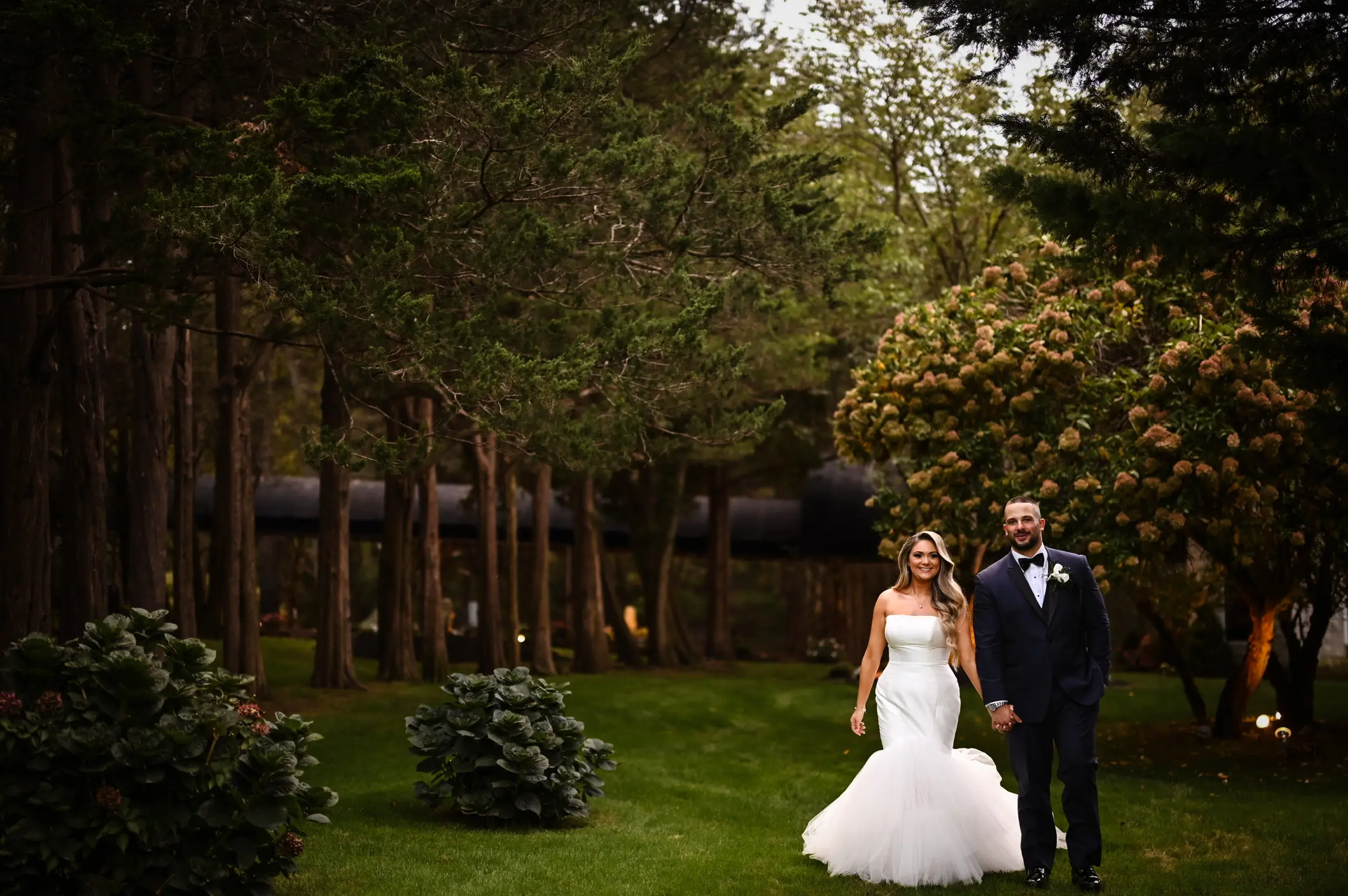 Bride wearing Holden wedding dress by Sottero and Midgley holding hands with the groom
