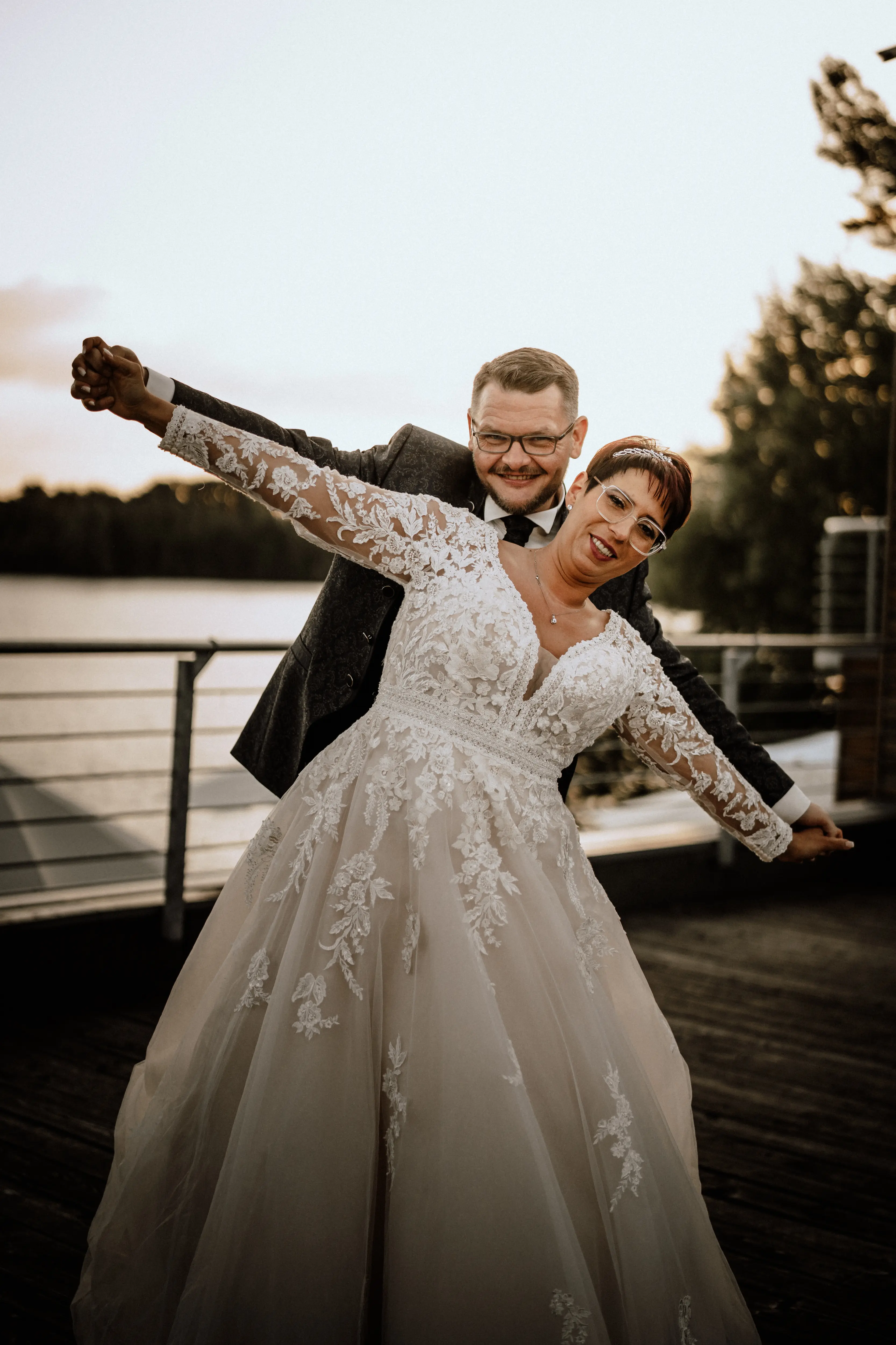 Bride in Long Sleeve Ivory Wedding Dress Raphael with Groom
