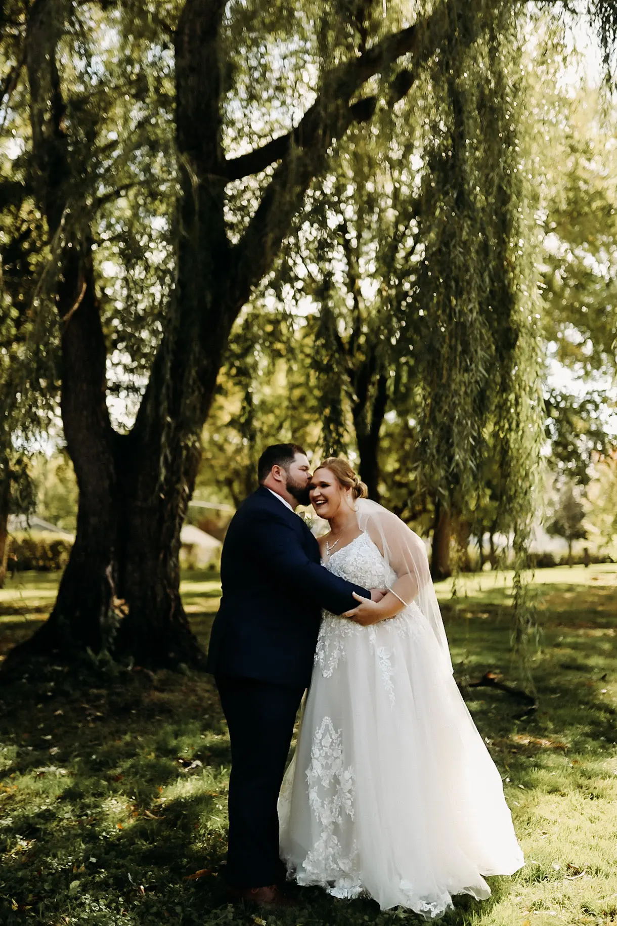 Bride wearing Pia wedding dress by Maggie Sottero kissed by her husband