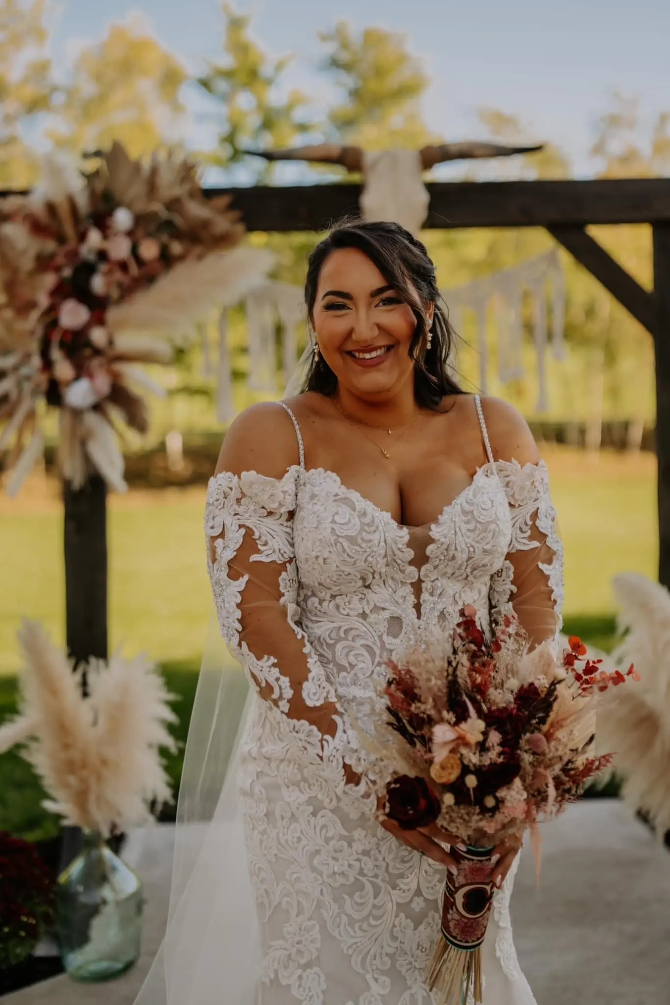 Bride wearing Fiona wedding dress by Maggie Sottero holding a bouquet