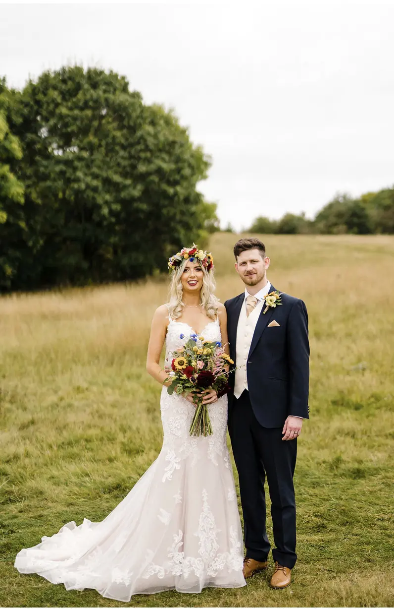 Groom and Bride Wearing Elegant Fit-and-Flare Bridal Dress by Maggie Sottero