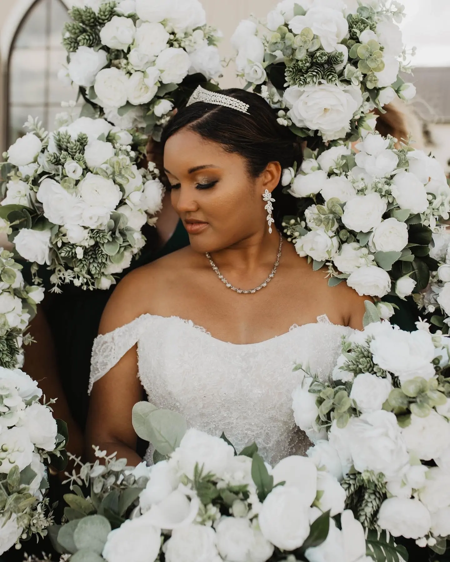 Bride Wearing Sparkly Ballgown Wedding Dress Called Zartasha By Sottero and Midgley Surrounded By White Flowers
