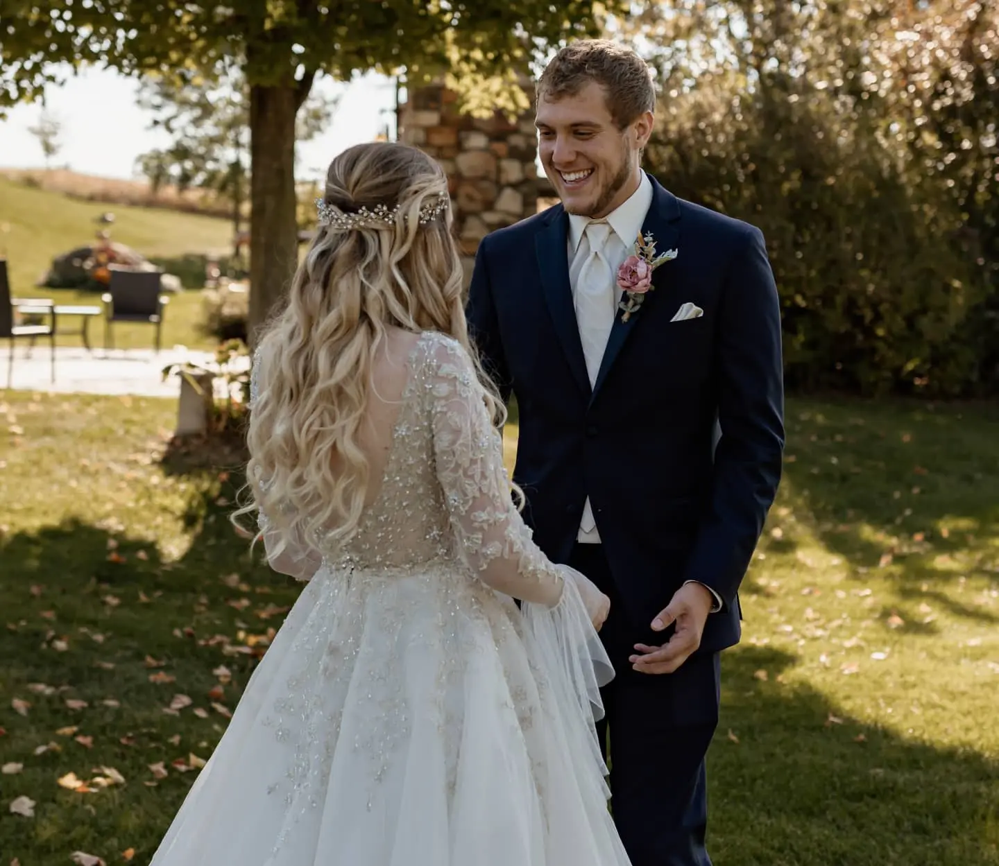Groom laughing with his bride who is wearing wedding dress called Talia with altered added sleeves.
