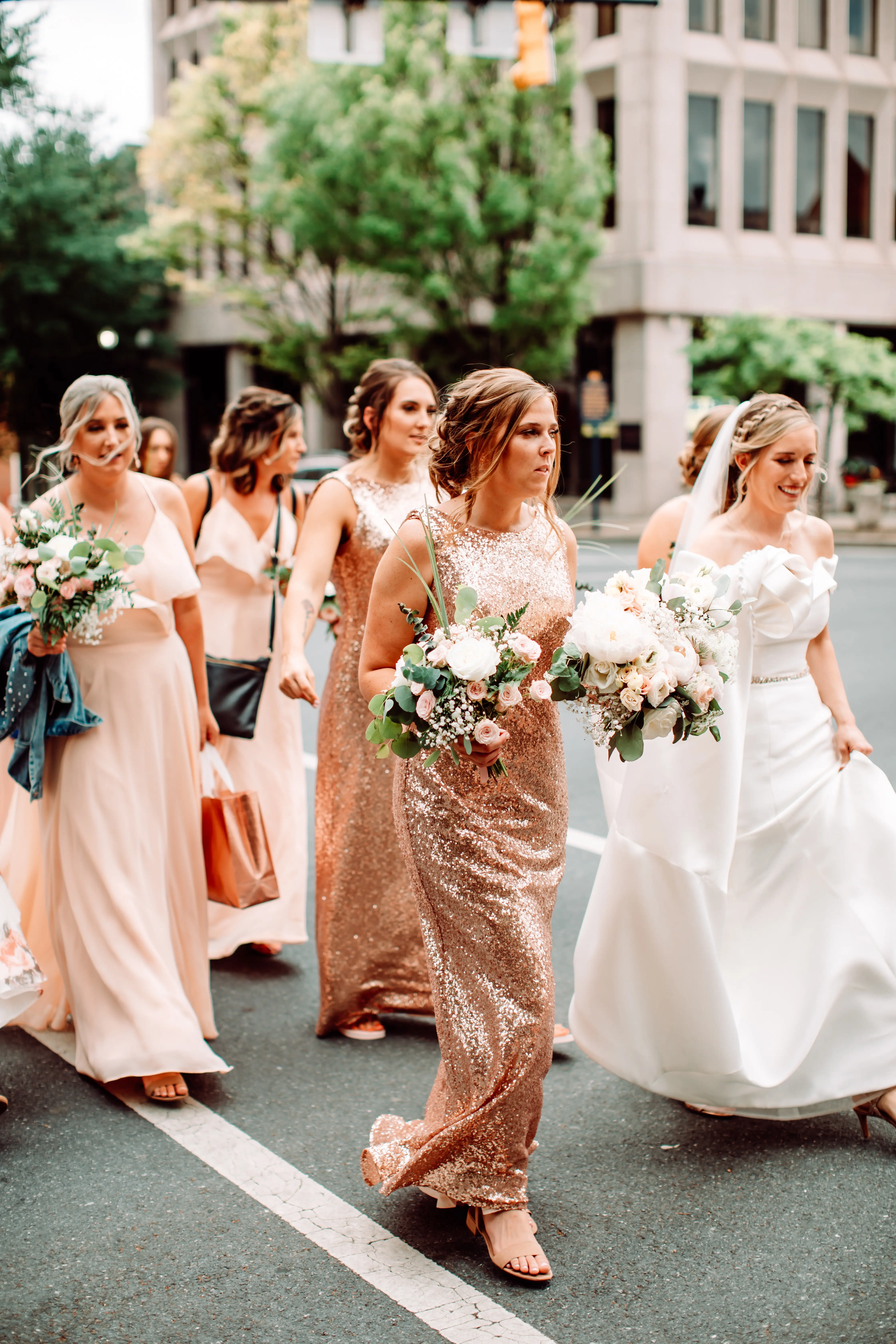 Bride with her bridesmaids crossing the road.