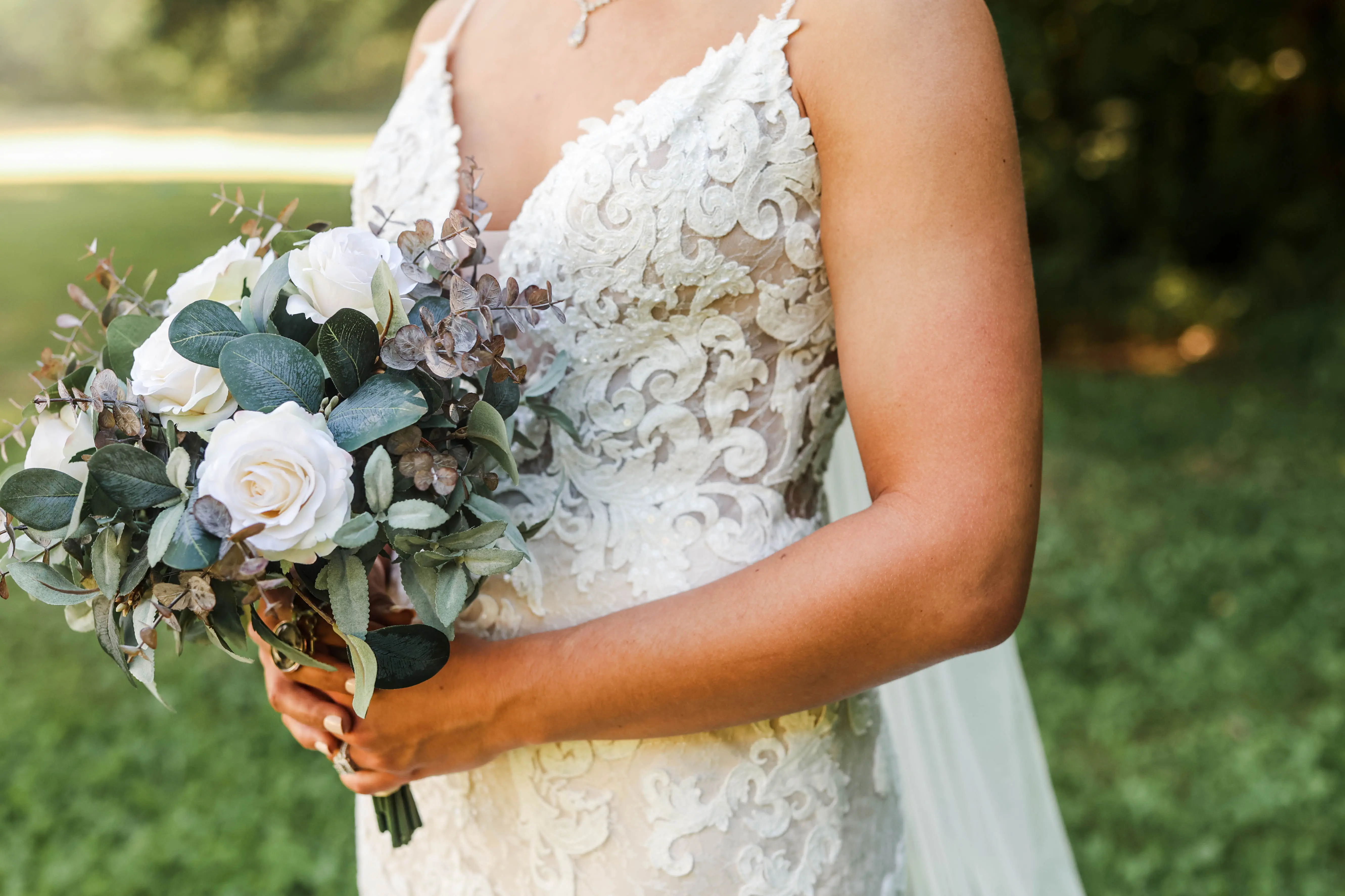 Bride wearing romantic lace sheath wedding dress