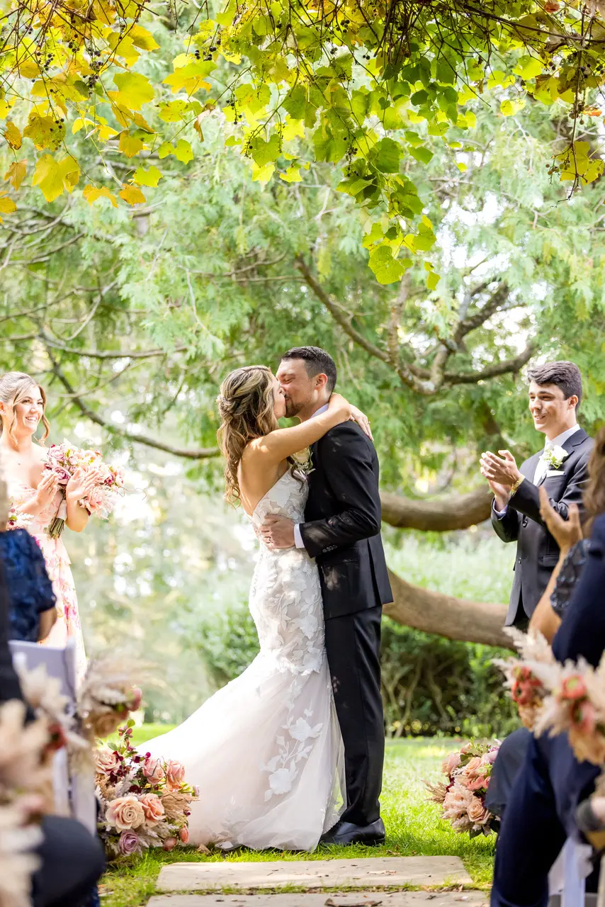Bride wearing Hattie Marie by Rebecca Ingram kissing her husband