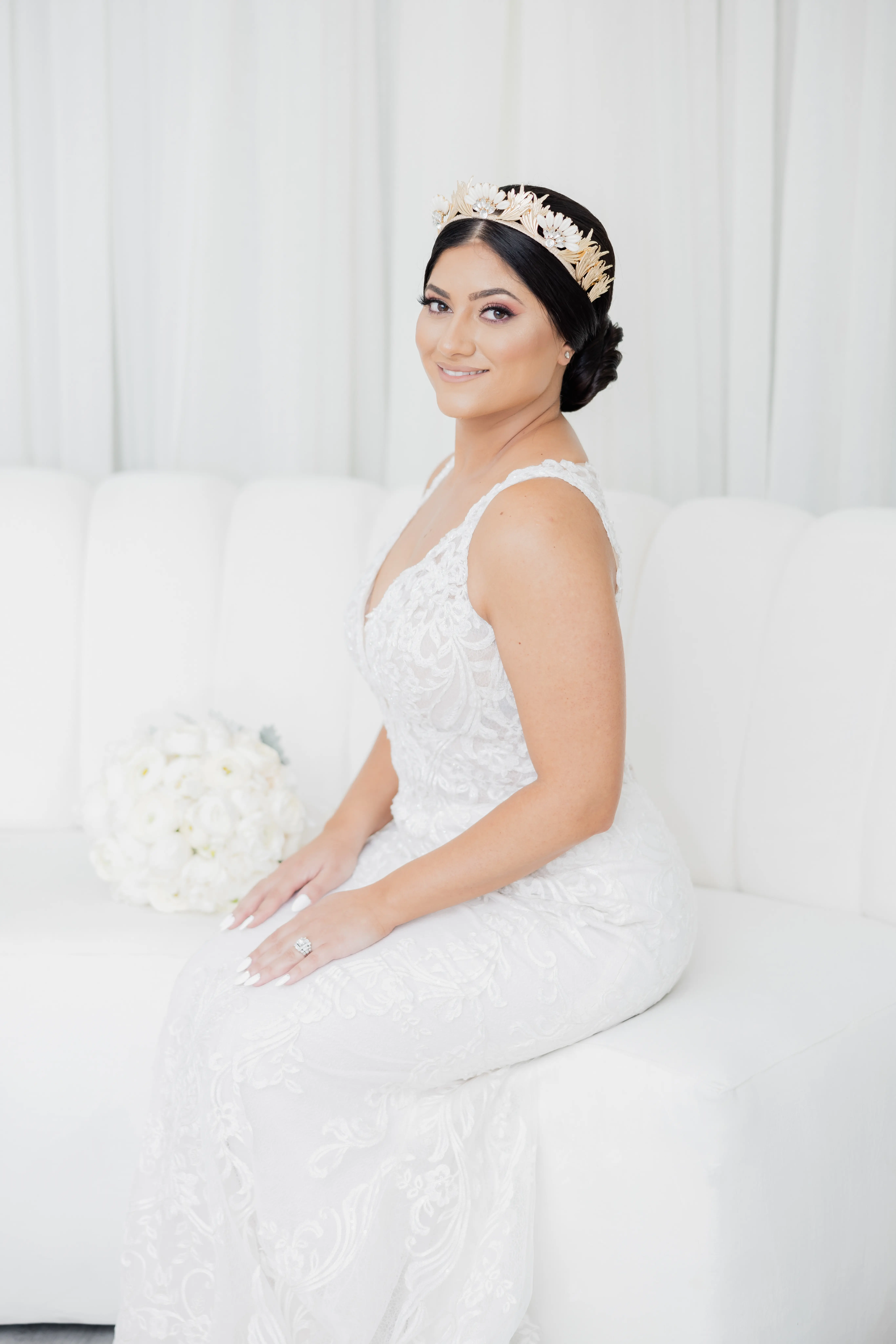 Bride Wearing Vintage Inspired Dramatic Back Wedding Dress Called Hamilton By Sottero And Midgley Sitting On White Couch