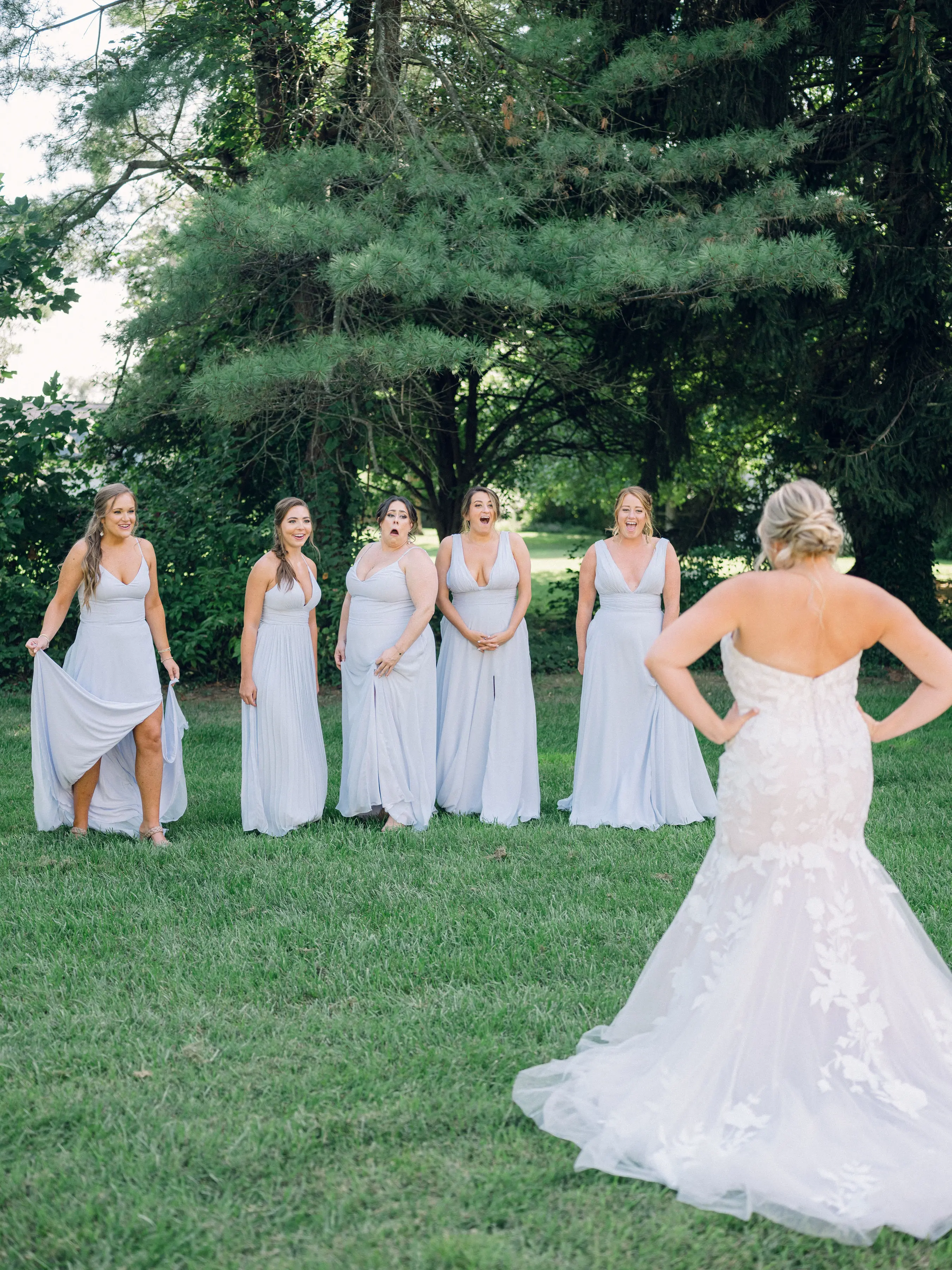 Bride Wearing Lace Mermaid Wedding Gown Called Hattie By Rebecca Ingram Showing Bridesmaids Her Dress