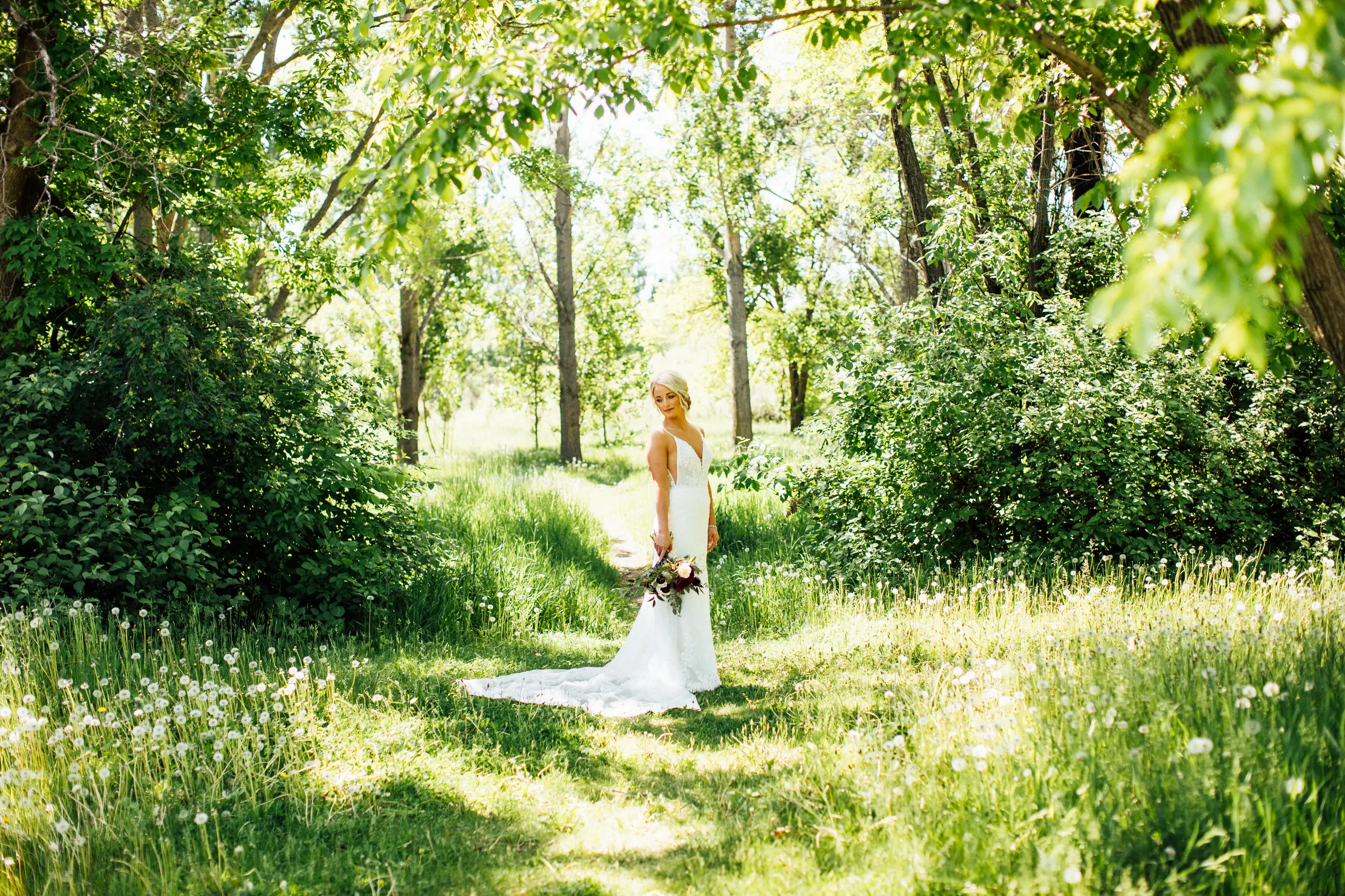 Bride Wearing Graceful Sparkly Lace Wedding Dress Called Fontaine By Maggie Sottero In A Green Meadow