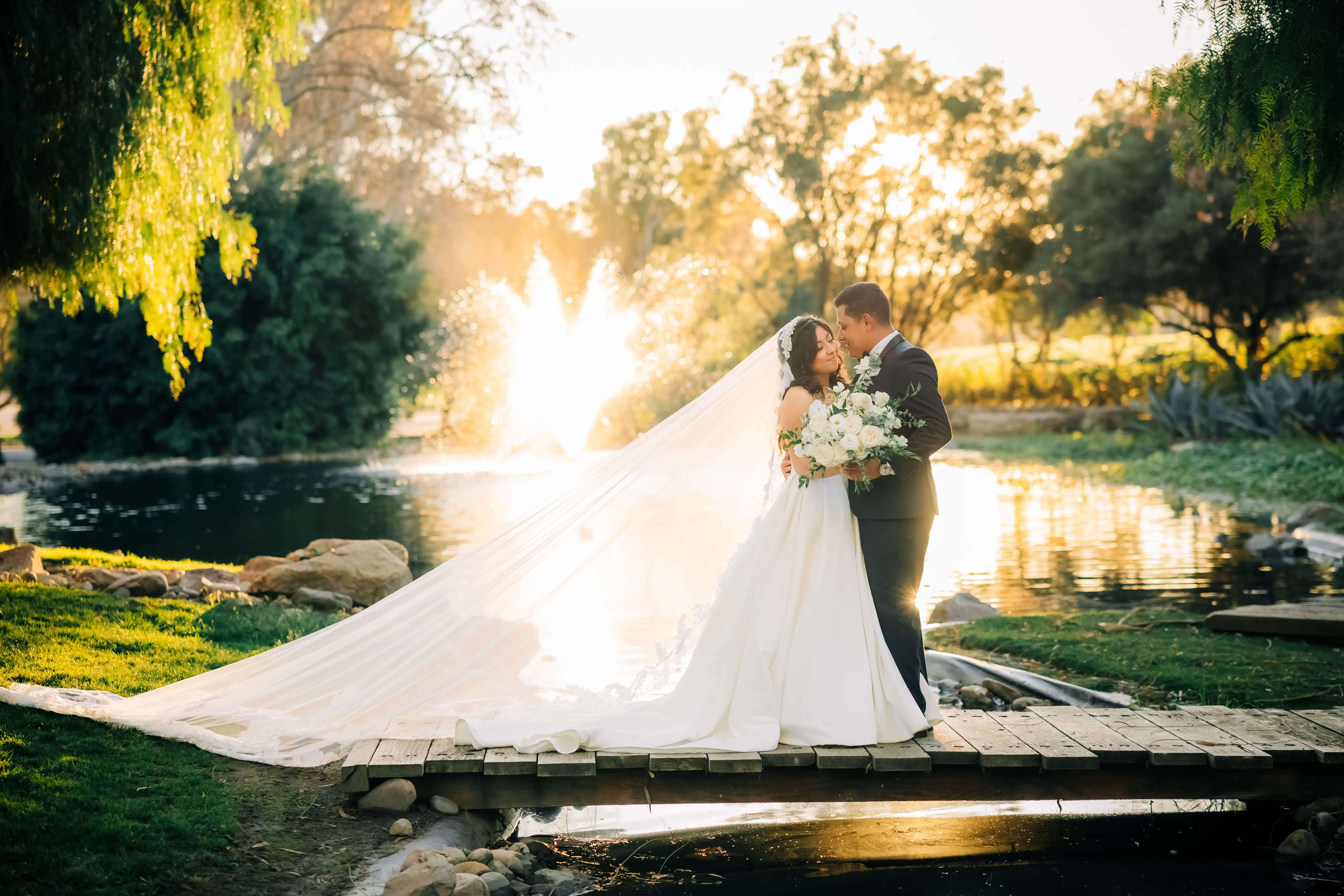 Bride Wearing Sexy Ballgown Wedding Dress Called Derrick By Maggie Sottero With Groom Next To A Pond