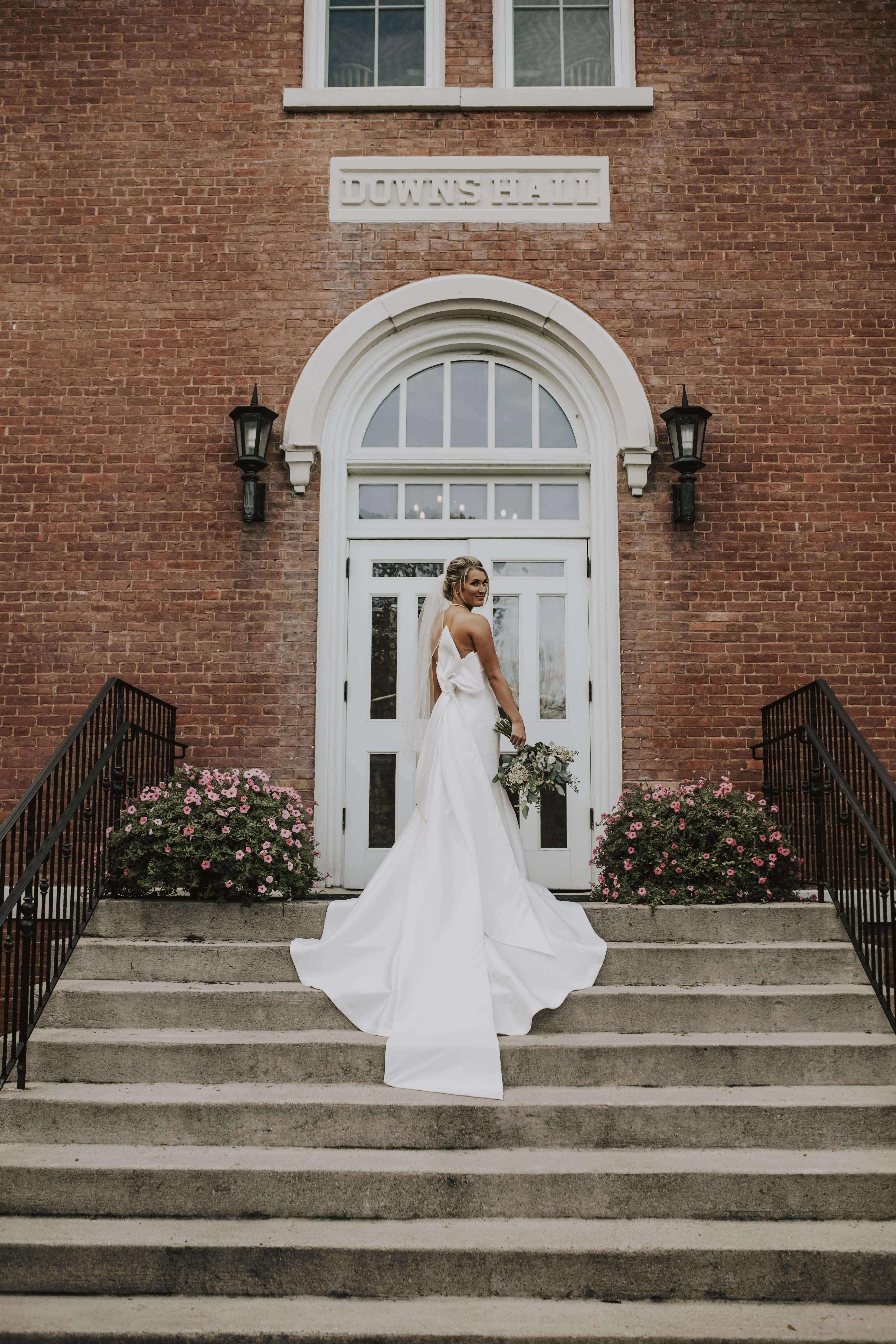 Bride wearing Mitchell wedding dress by Maggie Sottero on stairs