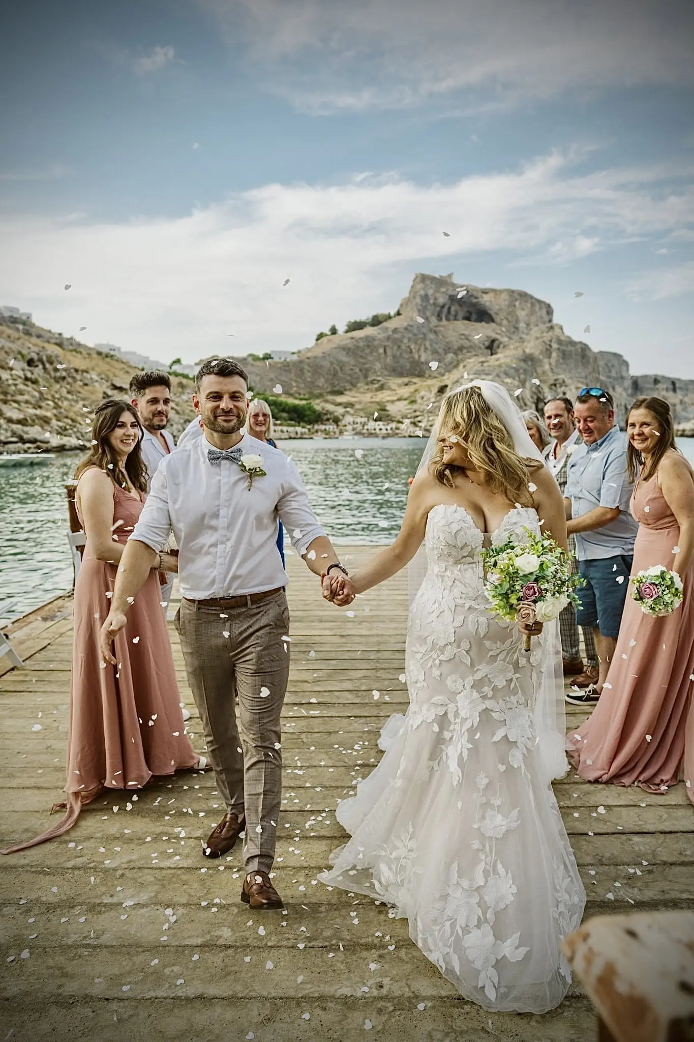 Bride wearing Hattie wedding dress by Rebecca Ingram with her groom at their exit