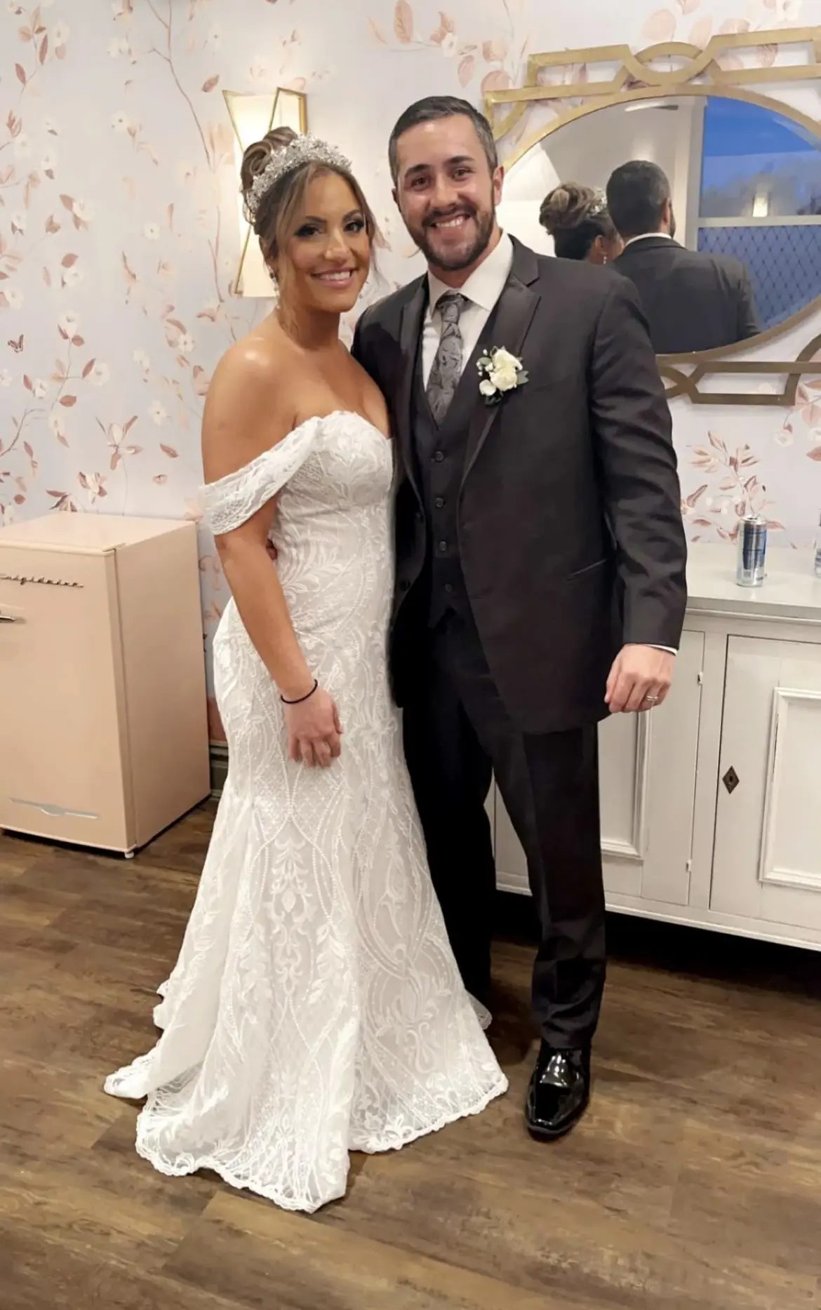 Bride wearing Bronson wedding dress by Sottero and Midgley standing with her husband