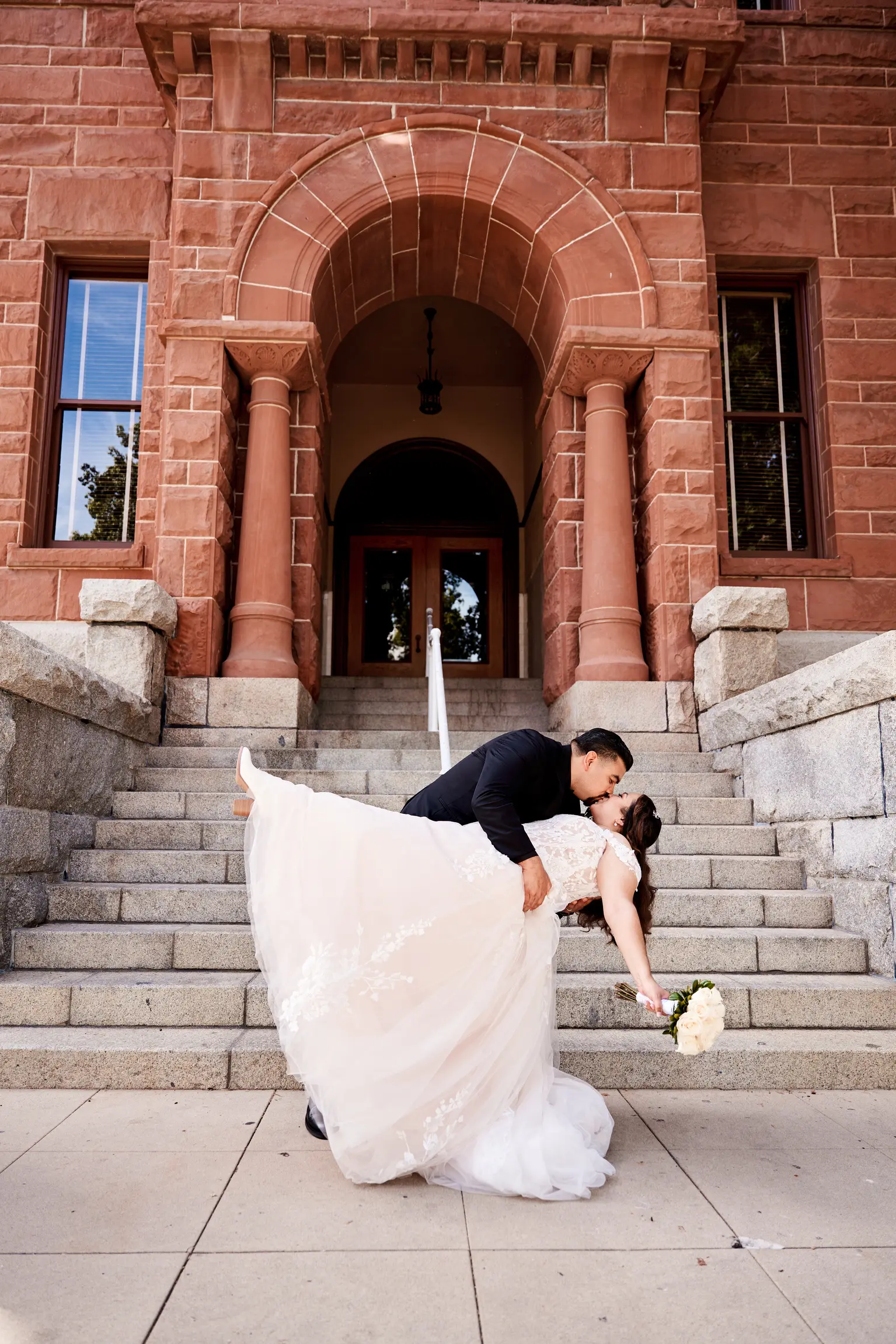 Groom Kissing And Dipping Bride Wearing Lace Ballgown Wedding Dress Called Harlem By Maggie Sottero