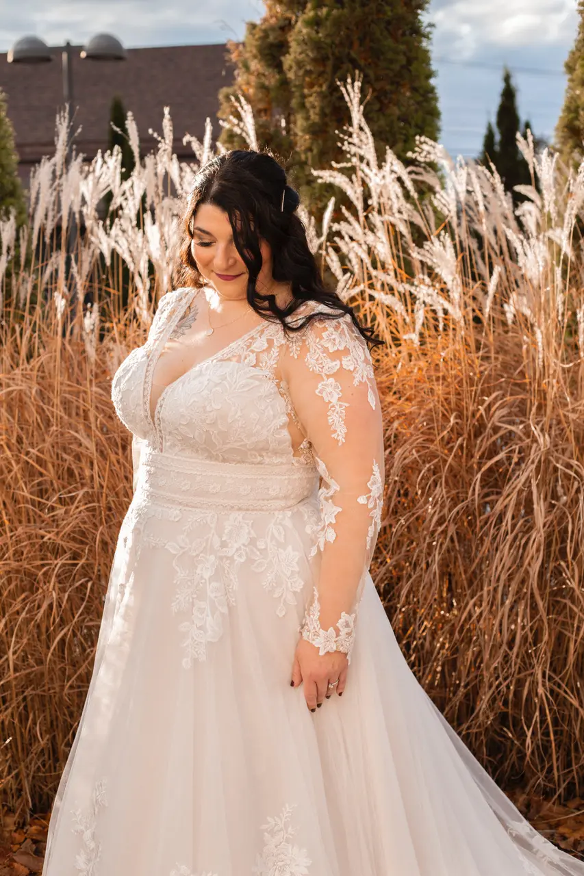 Bride glowing in sunshine wearing wedding dress called Raphael.