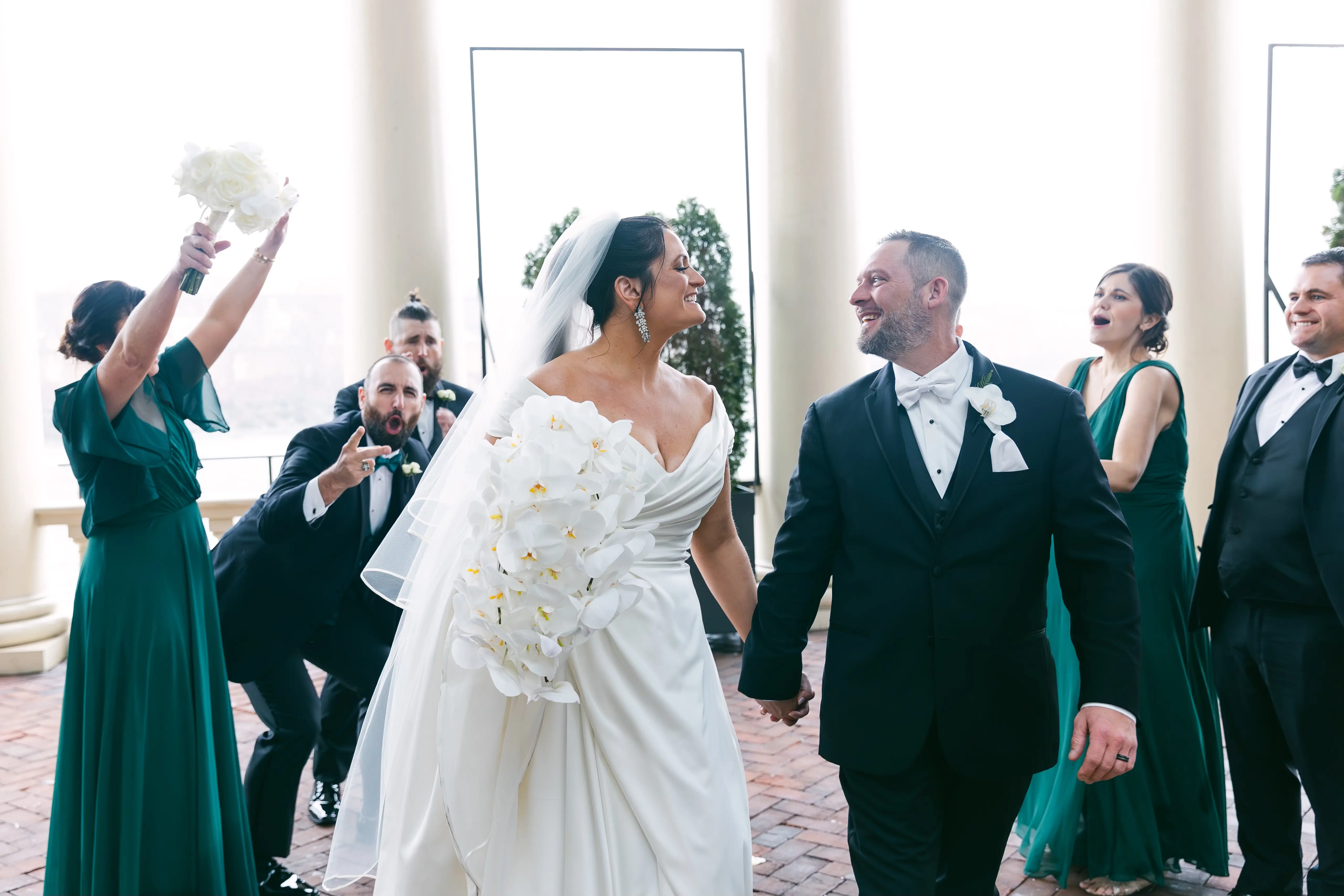 Bride wearing Ekaterina by Maggie Sottero leaving their ceremony with her husband