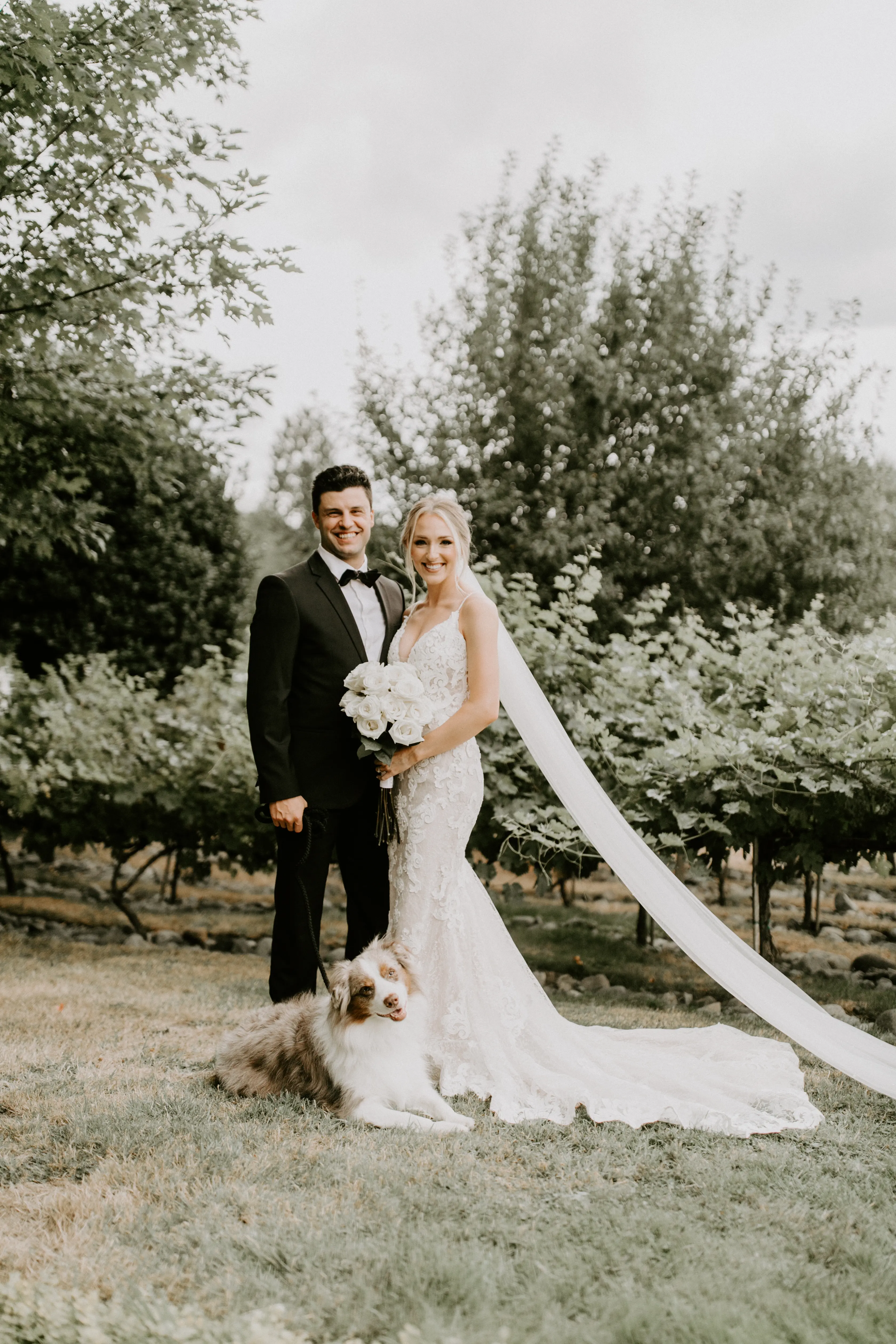 Bride with groom wearing romantic lace sheath wedding dress